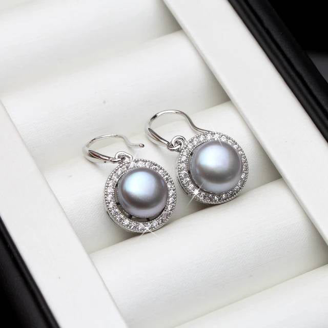 A pair of stunning drop earrings featuring genuine freshwater pearls in various colors, adorned with simulated diamonds for added elegance.