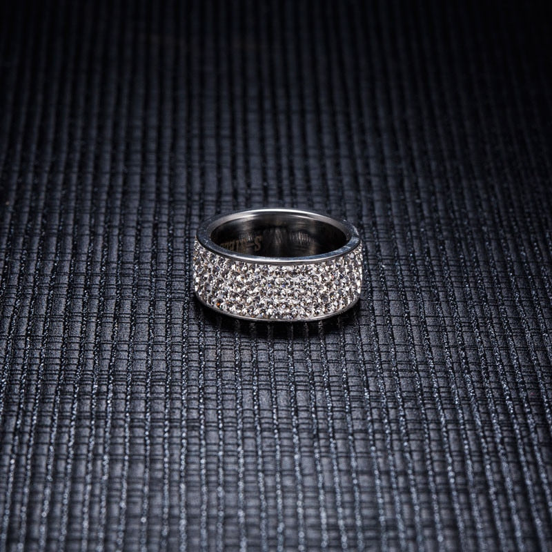 A stunning stainless steel band ring featuring simulated diamonds, showcasing a bold 8mm width and elegant design.