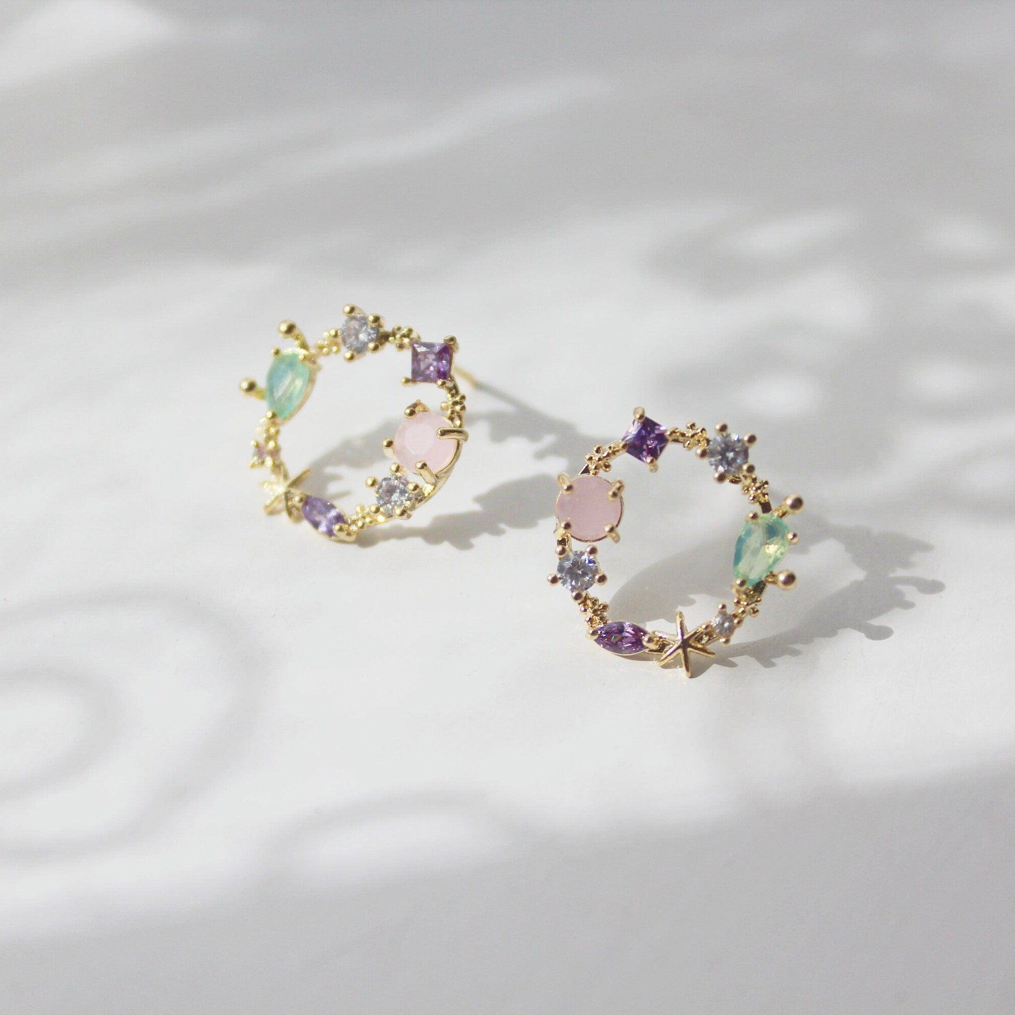 Summer Sea Treasures Earrings featuring seashell and starfish designs with purple crystals, set on sterling silver and gold plated bronze.