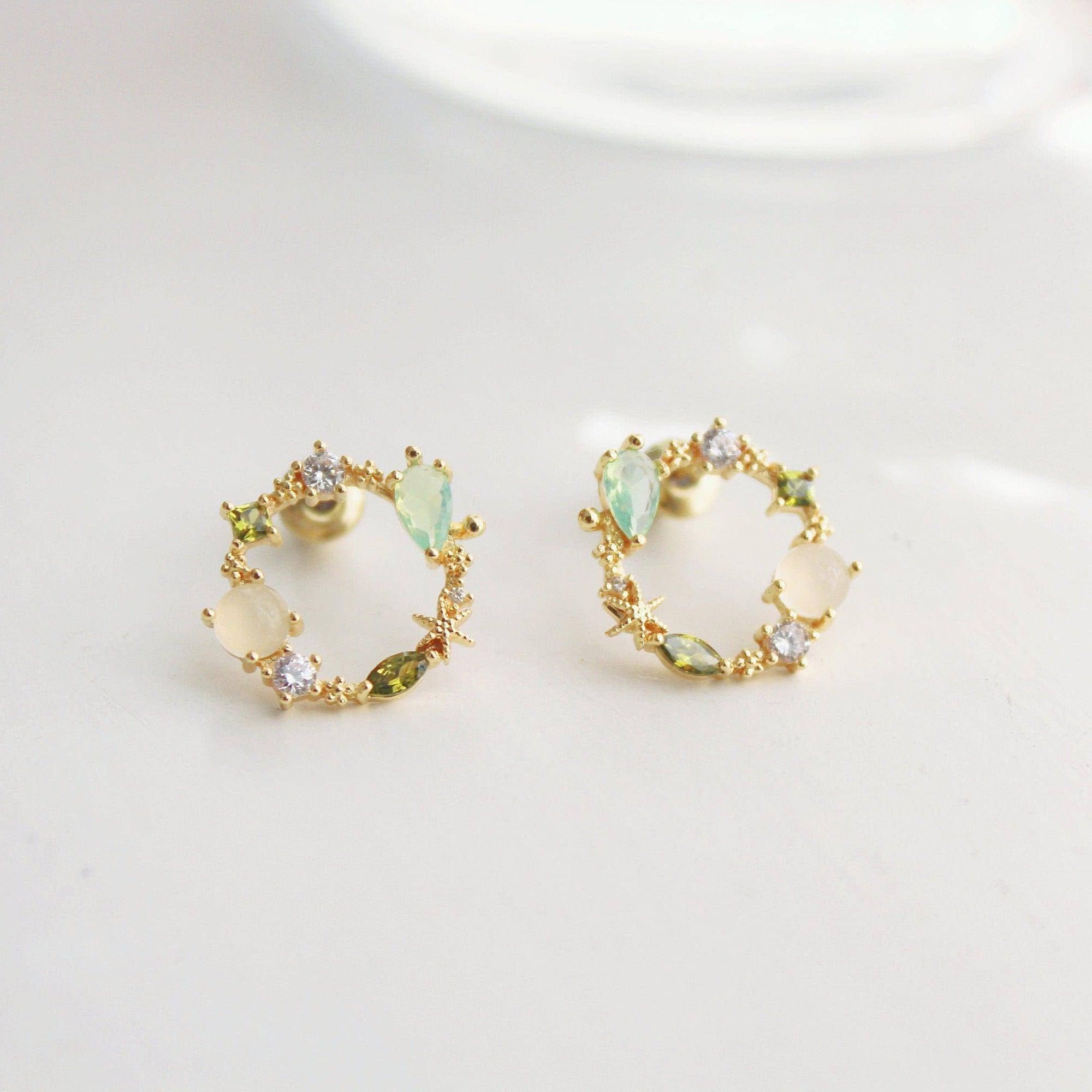 Summer Sea Treasures Earrings featuring seashell and starfish designs with purple crystals, set on sterling silver and gold plated bronze.