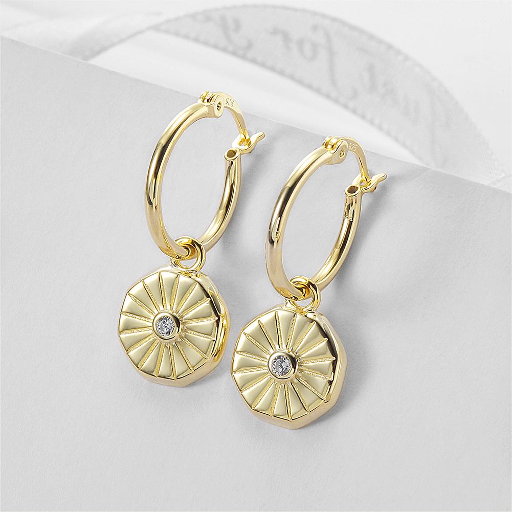 Elegant Sunburst Coin Huggie Earrings made of stainless steel with gold plating, showcasing a stylish sunburst design.