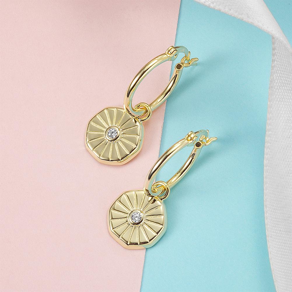 Elegant Sunburst Coin Huggie Earrings made of stainless steel with gold plating, showcasing a stylish sunburst design.