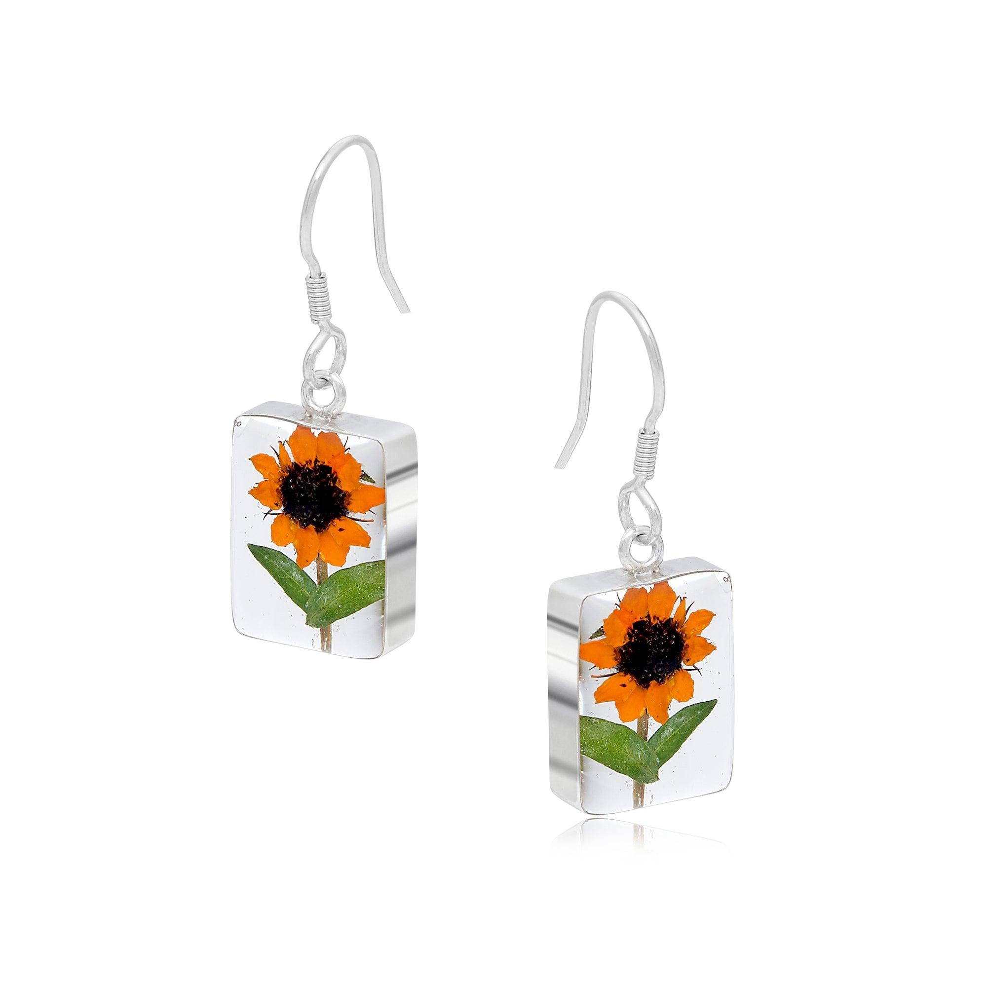 Sterling silver dangle drop earrings featuring real sunflowers, handmade by Shrieking Violet, showcasing vibrant yellow petals.