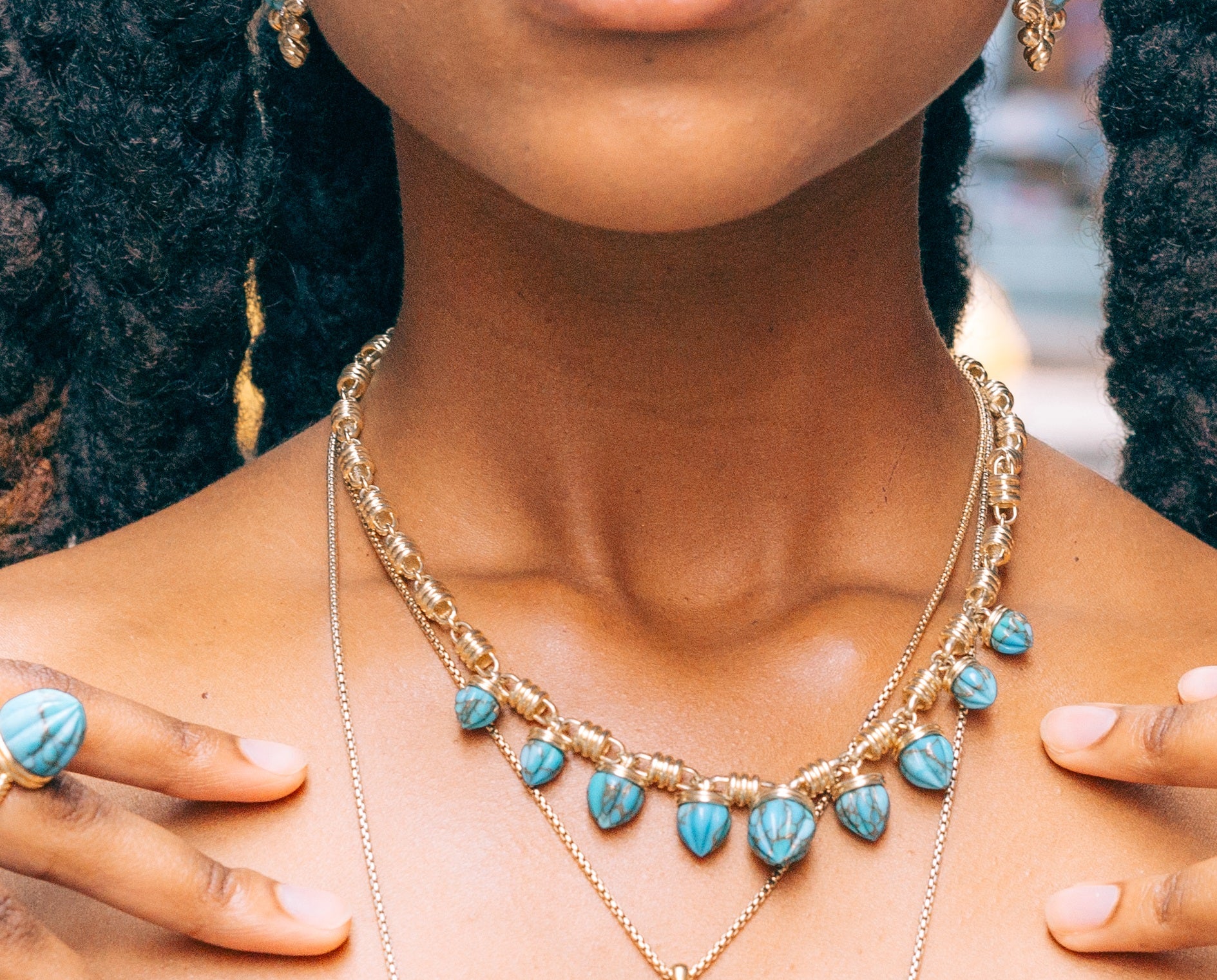 Sunshine Twist Turquoise Studded Necklace featuring carved turquoise stones and 14K yellow gold plating, elegantly displayed.