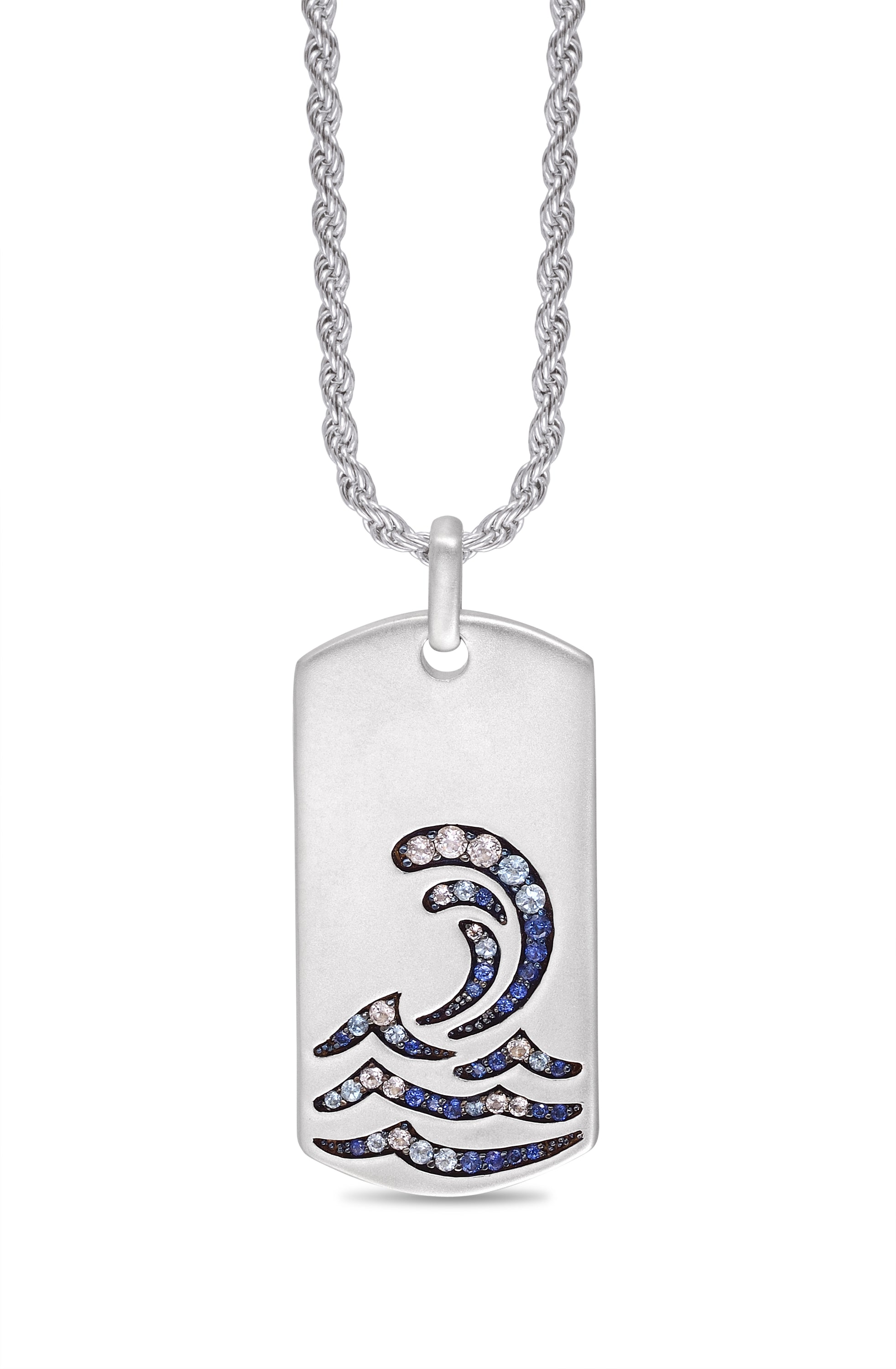 Surfrider Beach Tag in sterling silver featuring blue sapphire and topaz stones, showcasing an ocean-wave inspired design.