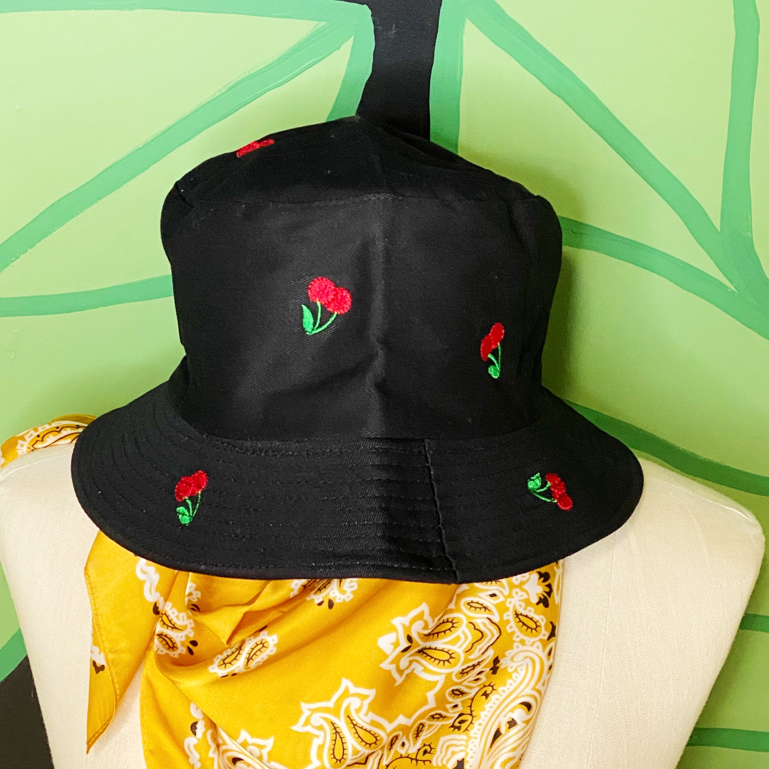 A stylish Sweety Fruity Bucket Hat featuring colorful embroidered fruit patterns on a high-quality cotton fabric, perfect for summer wear.