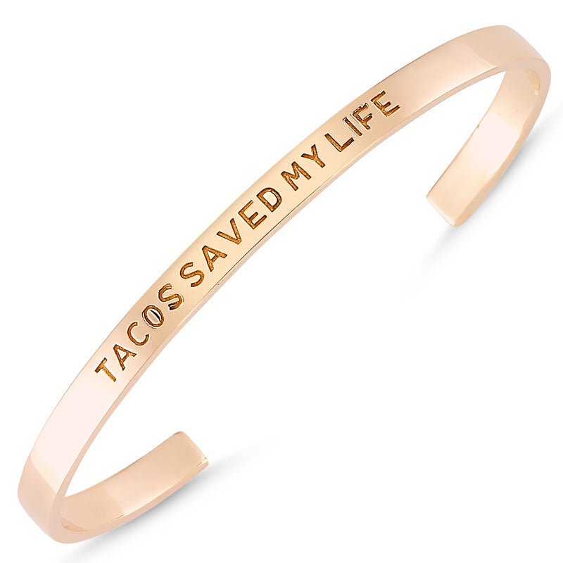 Handmade silver cuff bracelet engraved with 'Tacos Saved My Life', featuring 18K rose gold or rhodium plating.
