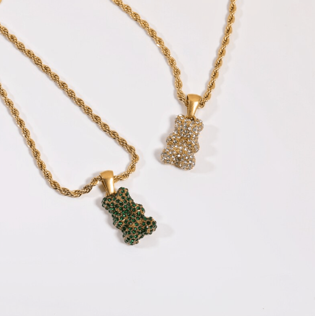 Tam Encrusted Teddy Bear Sparkle Charm Necklace featuring a teddy bear charm with sparkling crystals on a gold rope chain.