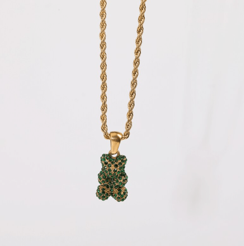 Tam Encrusted Teddy Bear Sparkle Charm Necklace featuring a teddy bear charm with sparkling crystals on a gold rope chain.