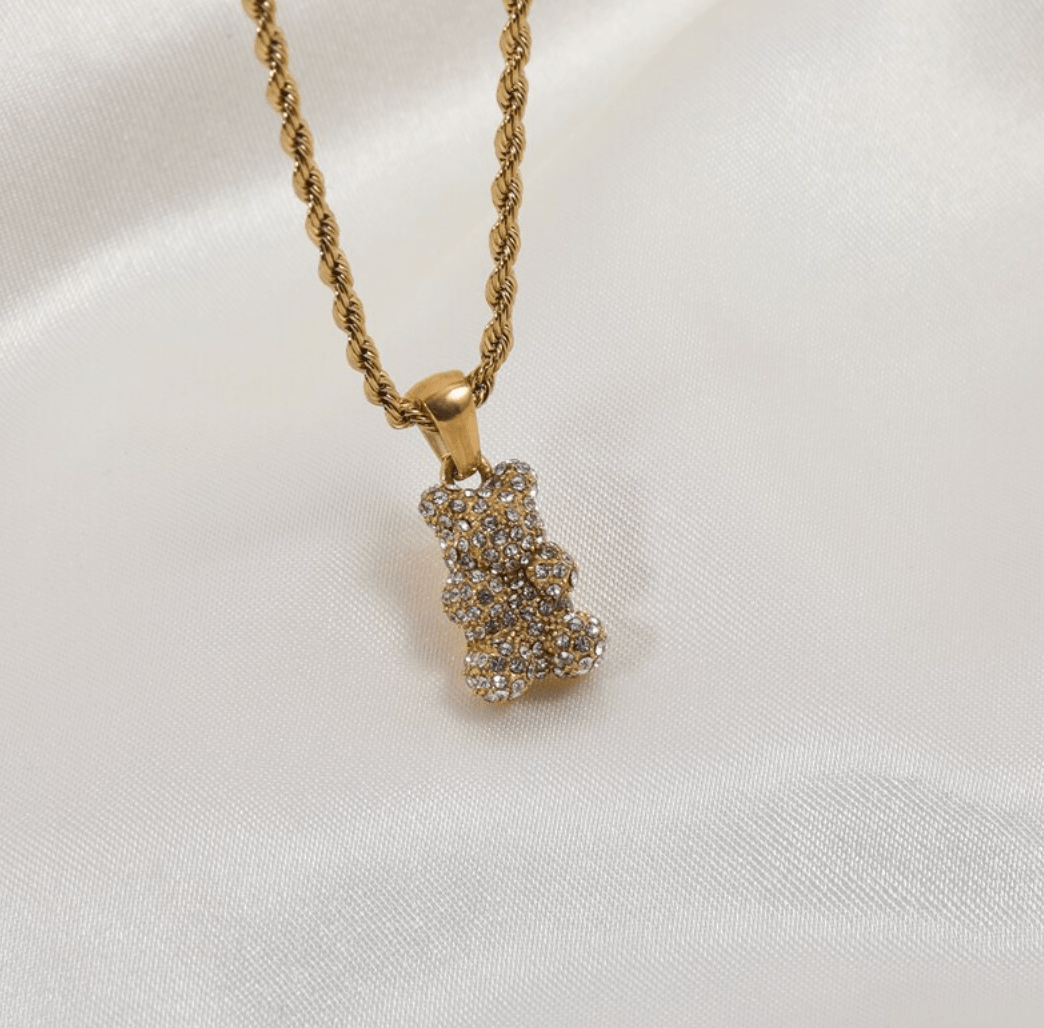 Tam Encrusted Teddy Bear Sparkle Charm Necklace featuring a teddy bear charm with sparkling crystals on a gold rope chain.
