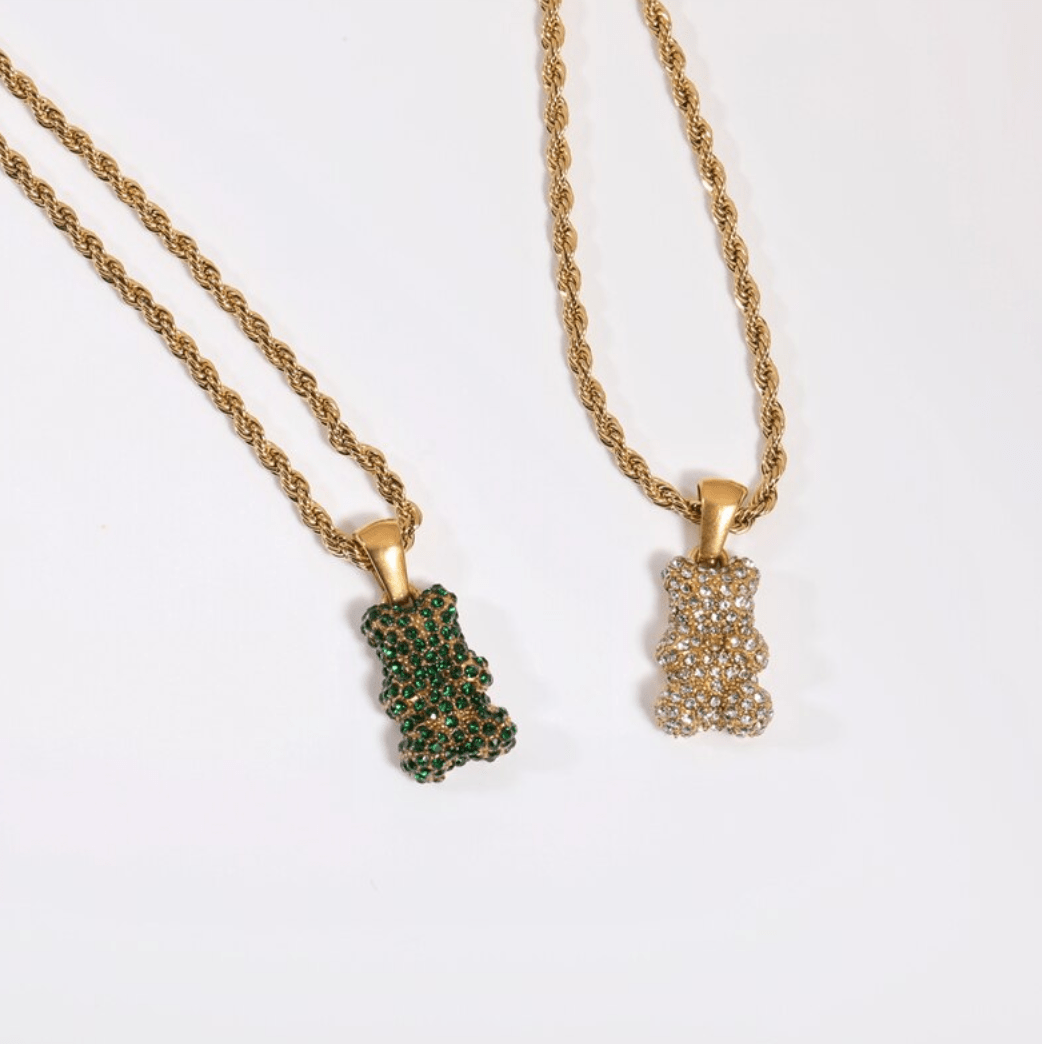 Tam Encrusted Teddy Bear Sparkle Charm Necklace featuring a teddy bear charm with sparkling crystals on a gold rope chain.