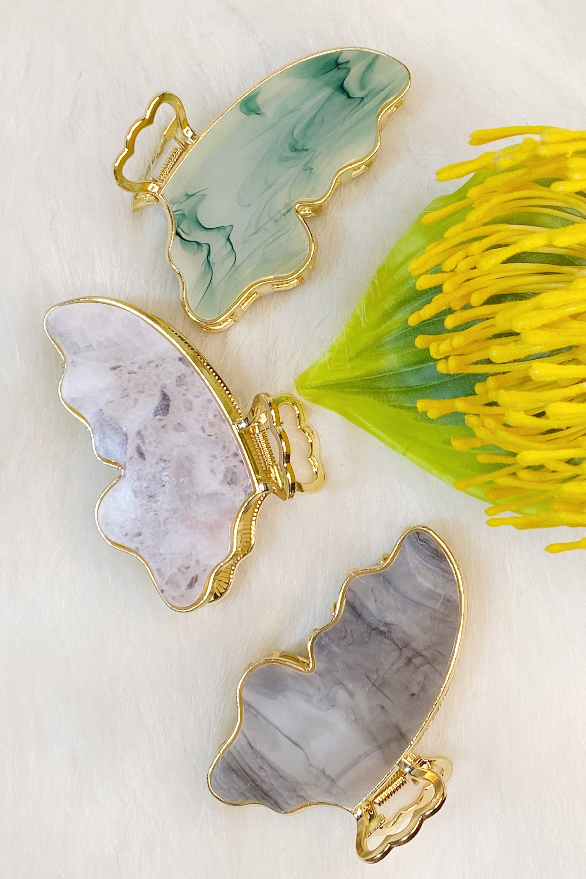 Taylor Butterfly Hair Claw featuring a beautiful butterfly design in resin and metal, perfect for securing hair stylishly.