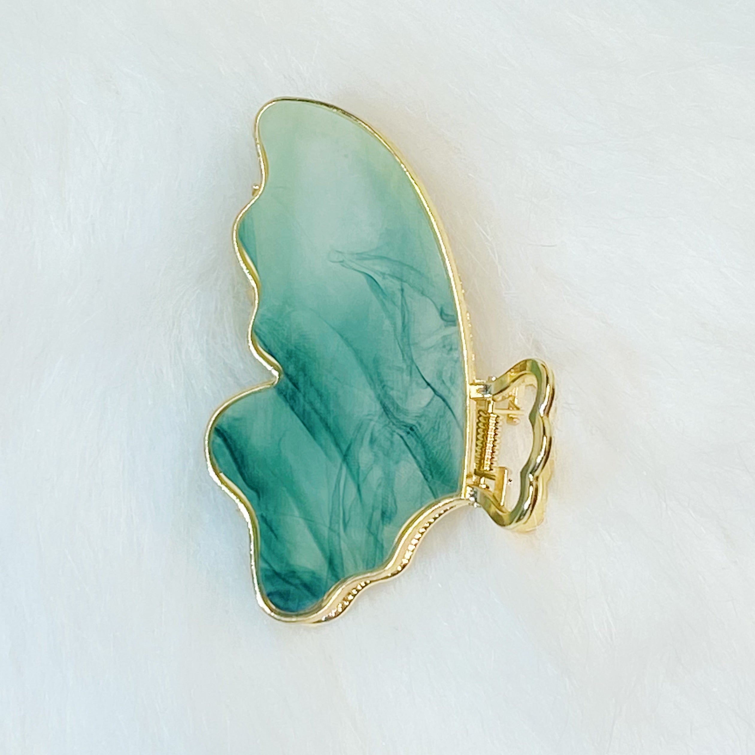 Taylor Butterfly Hair Claw featuring a beautiful butterfly design in resin and metal, perfect for securing hair stylishly.