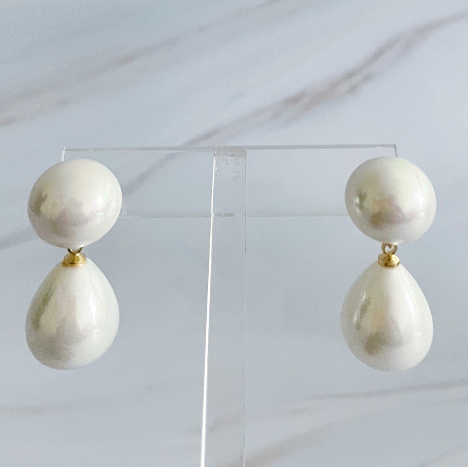 Elegant teardrop pearl earrings featuring lustrous glass pearls and 18k gold plated brass setting, perfect for any occasion.