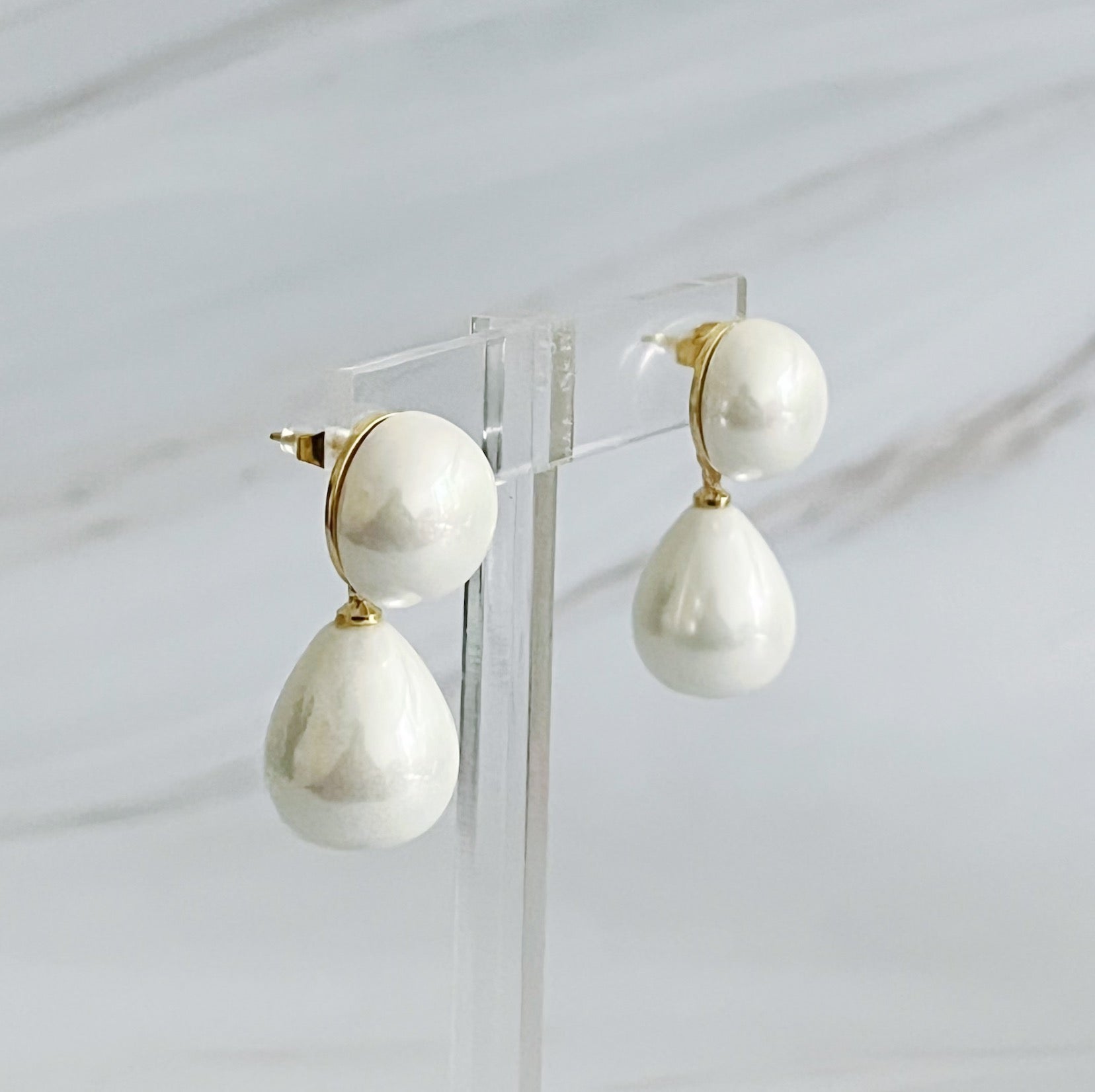 Elegant teardrop pearl earrings featuring lustrous glass pearls and 18k gold plated brass setting, perfect for any occasion.