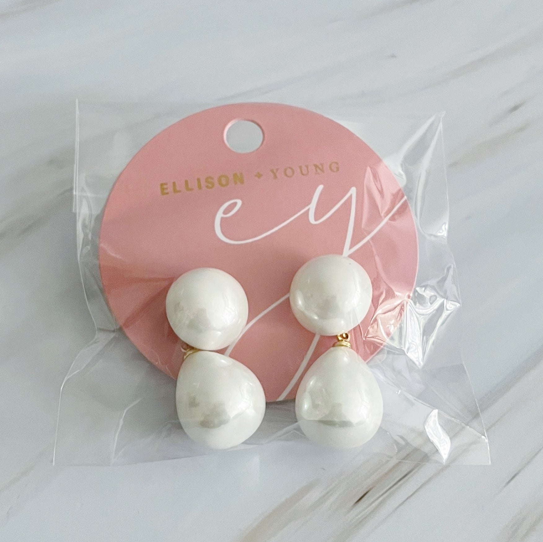 Elegant teardrop pearl earrings featuring lustrous glass pearls and 18k gold plated brass setting, perfect for any occasion.