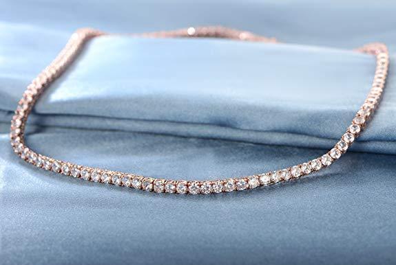 Elegant Tennis Necklace and Princess Halo Earring Set in 18K rose gold with Austrian crystals, displayed in a luxe gift box.