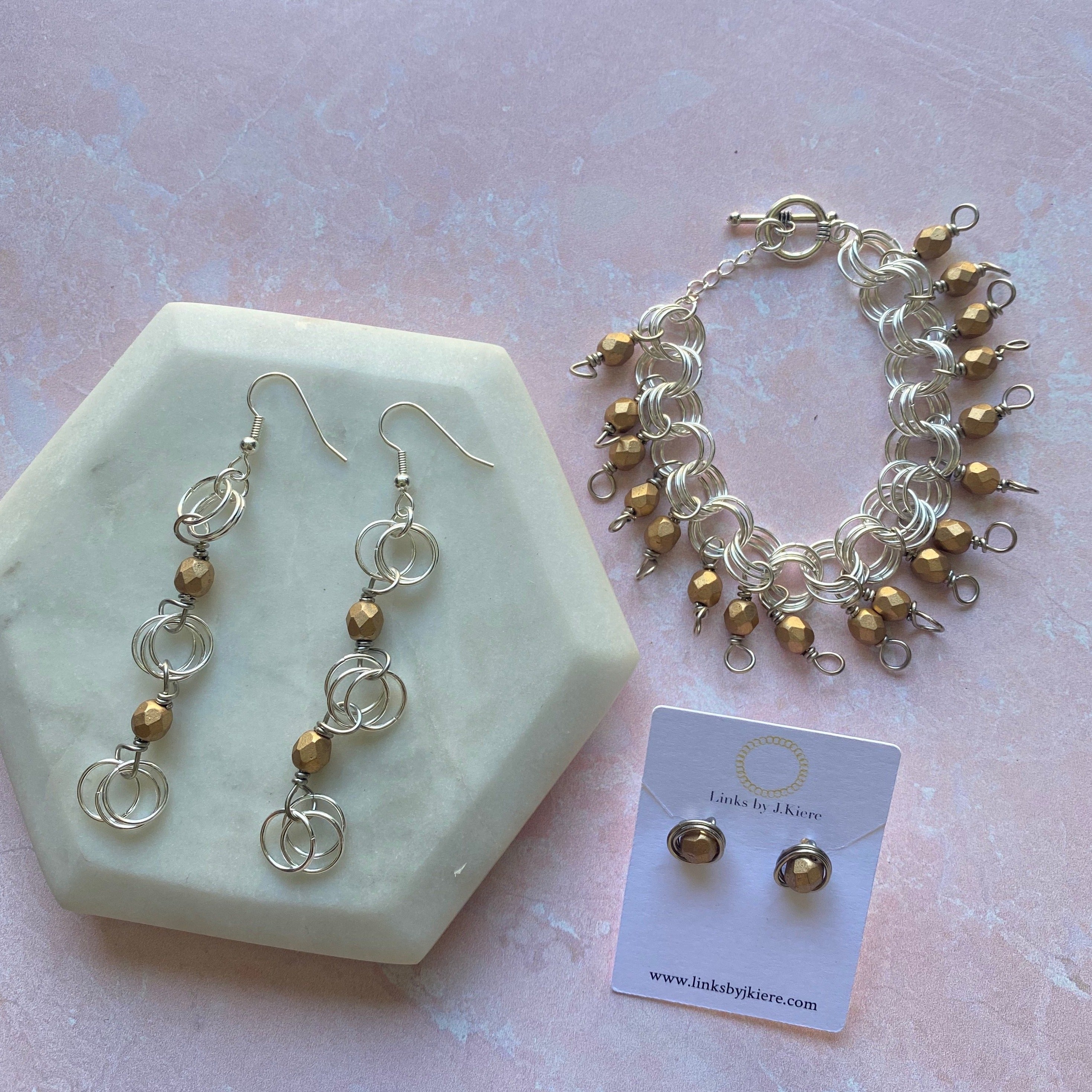 The Donna Bracelet in Satin Gold featuring Czech glass beads and a toggle clasp, showcasing its elegant design and craftsmanship.