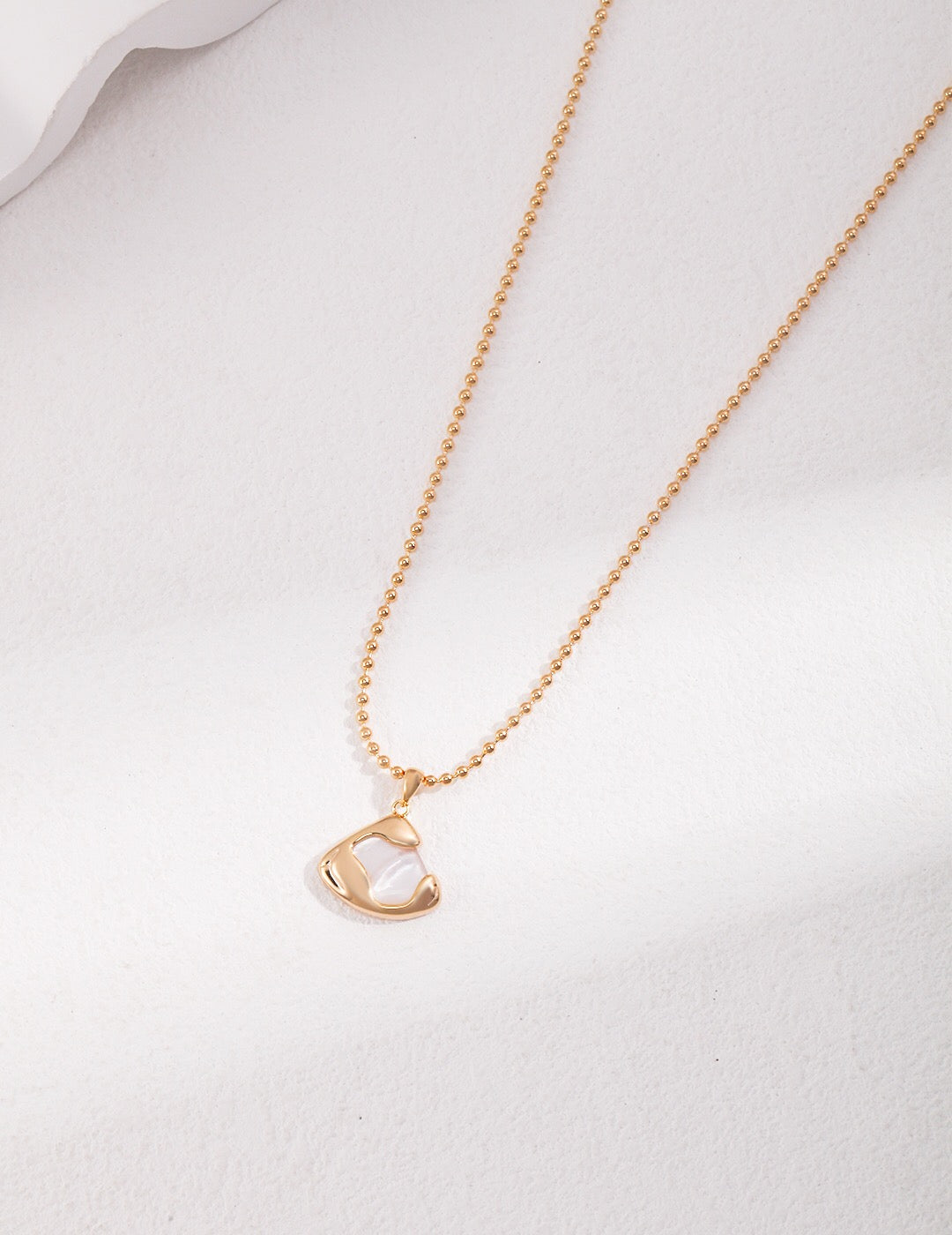 Ethereal Mother-of-Pearl Skirt Pendant Necklace featuring a gold vermeil chain and a stunning mother-of-pearl pendant.