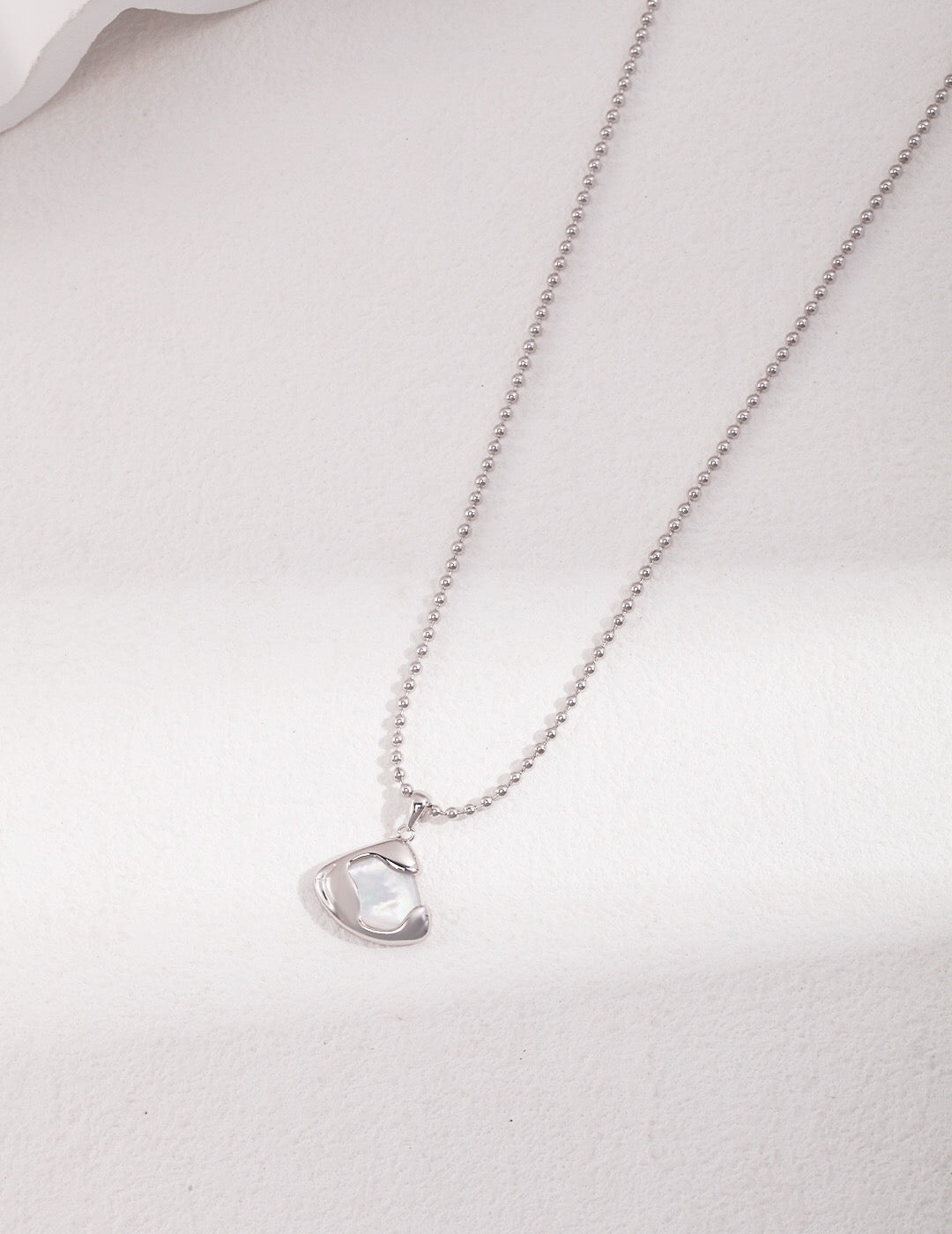 Ethereal Mother-of-Pearl Skirt Pendant Necklace featuring a gold vermeil chain and a stunning mother-of-pearl pendant.