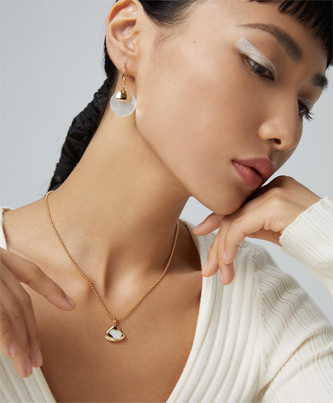 Ethereal Mother-of-Pearl Skirt Pendant Necklace featuring a gold vermeil chain and a stunning mother-of-pearl pendant.