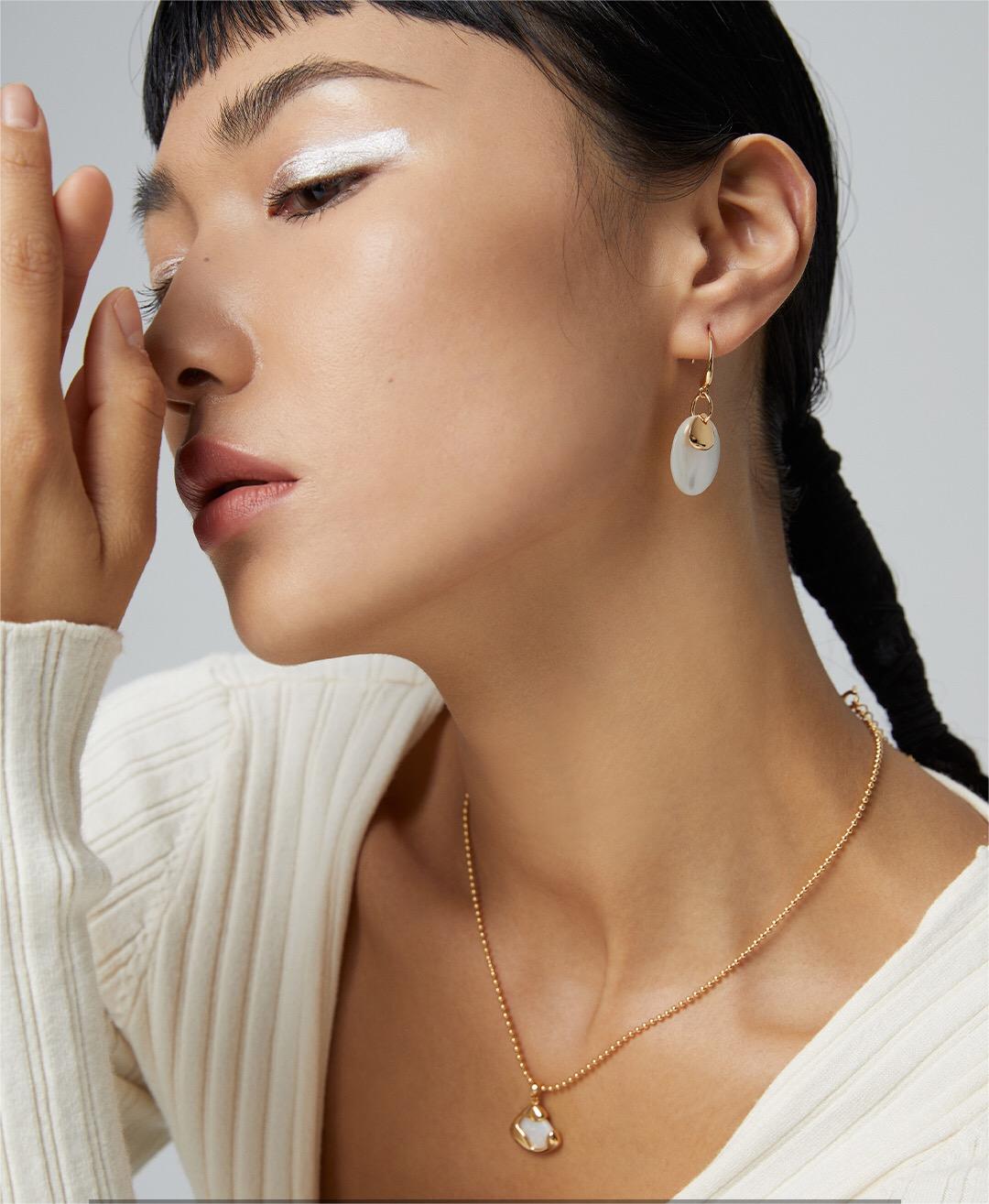 Ethereal Mother-of-Pearl Skirt Pendant Necklace featuring a gold vermeil chain and a stunning mother-of-pearl pendant.