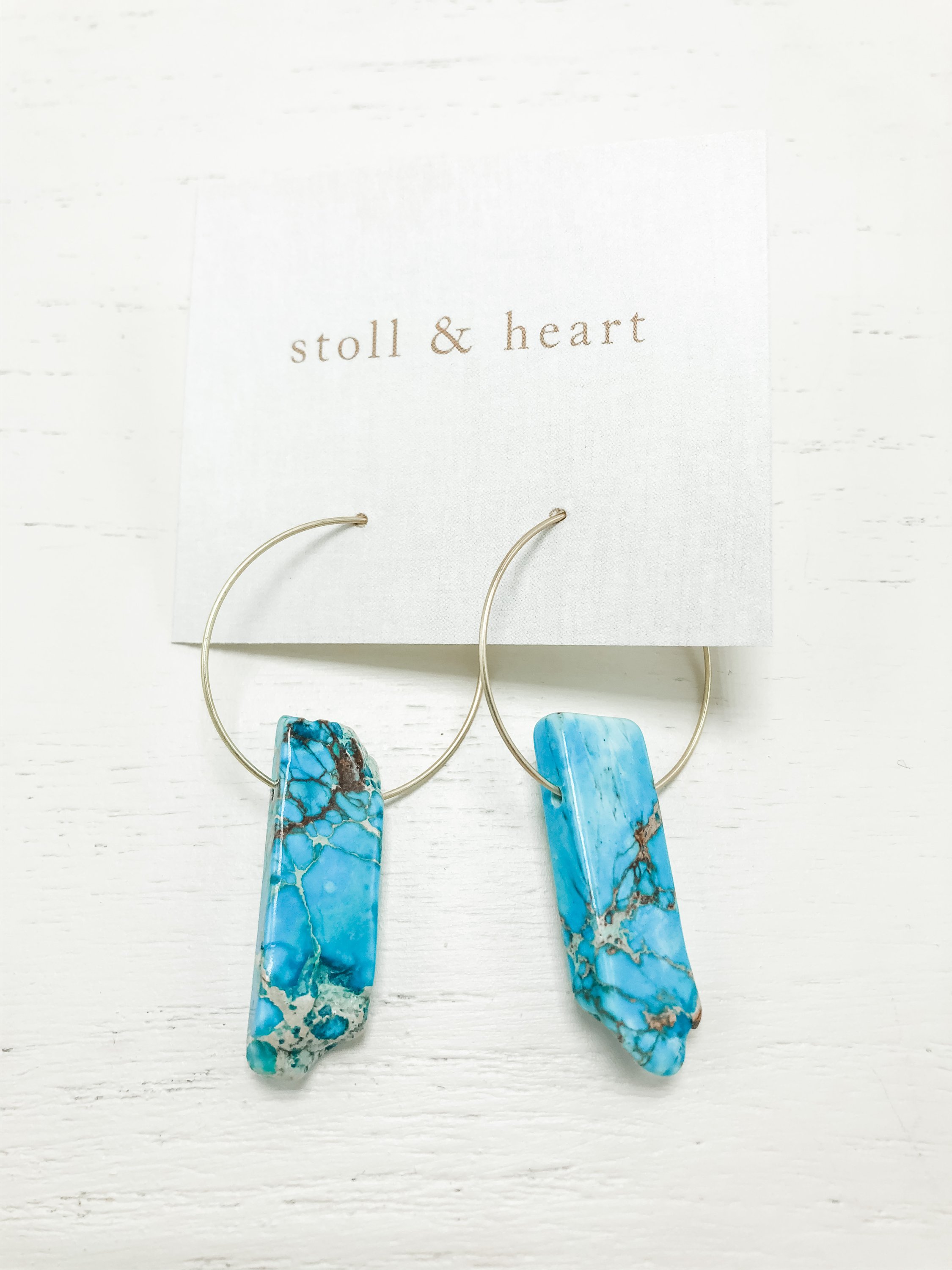 Gold plated hoop earrings featuring natural amazonite stones, showcasing their unique colors and patterns.
