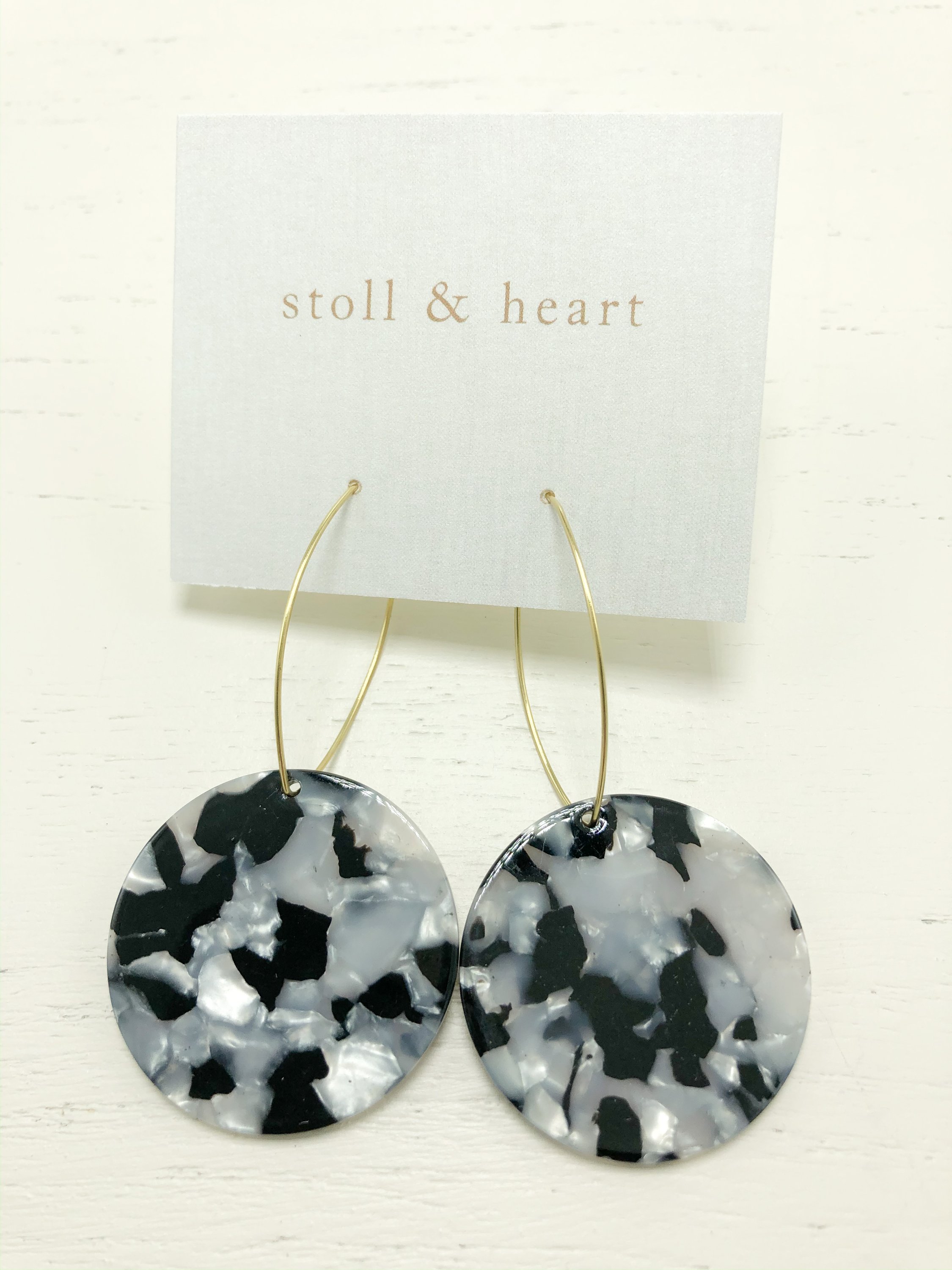 Maddy Roundies earrings featuring black and white tortoise resin detail on brass hoops, measuring 2-3/4 inches in length.