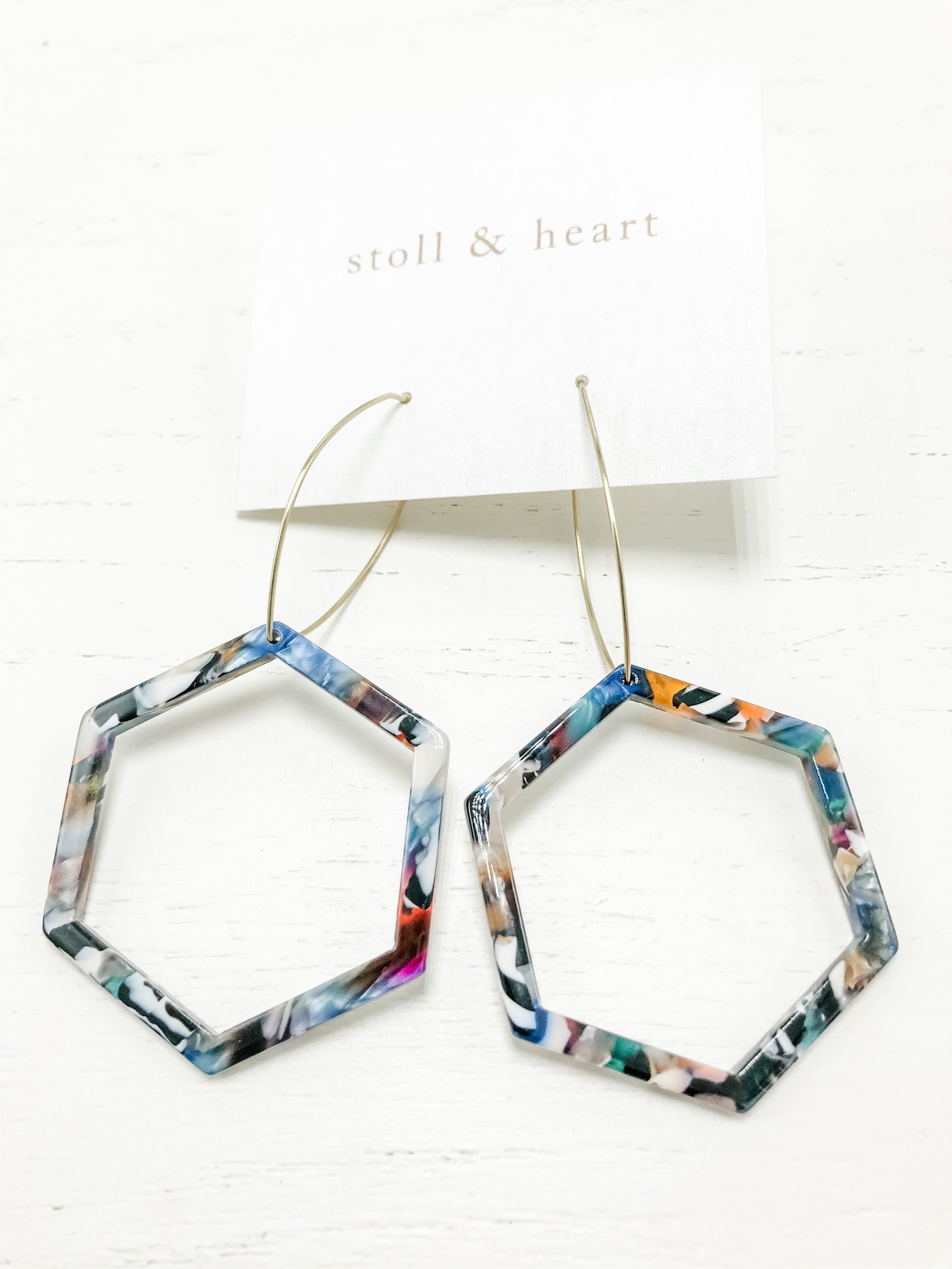 The Mae Multi-Color Tortoise earrings featuring brass hoops and vibrant tortoise shell resin detail, measuring 3 inches in length.