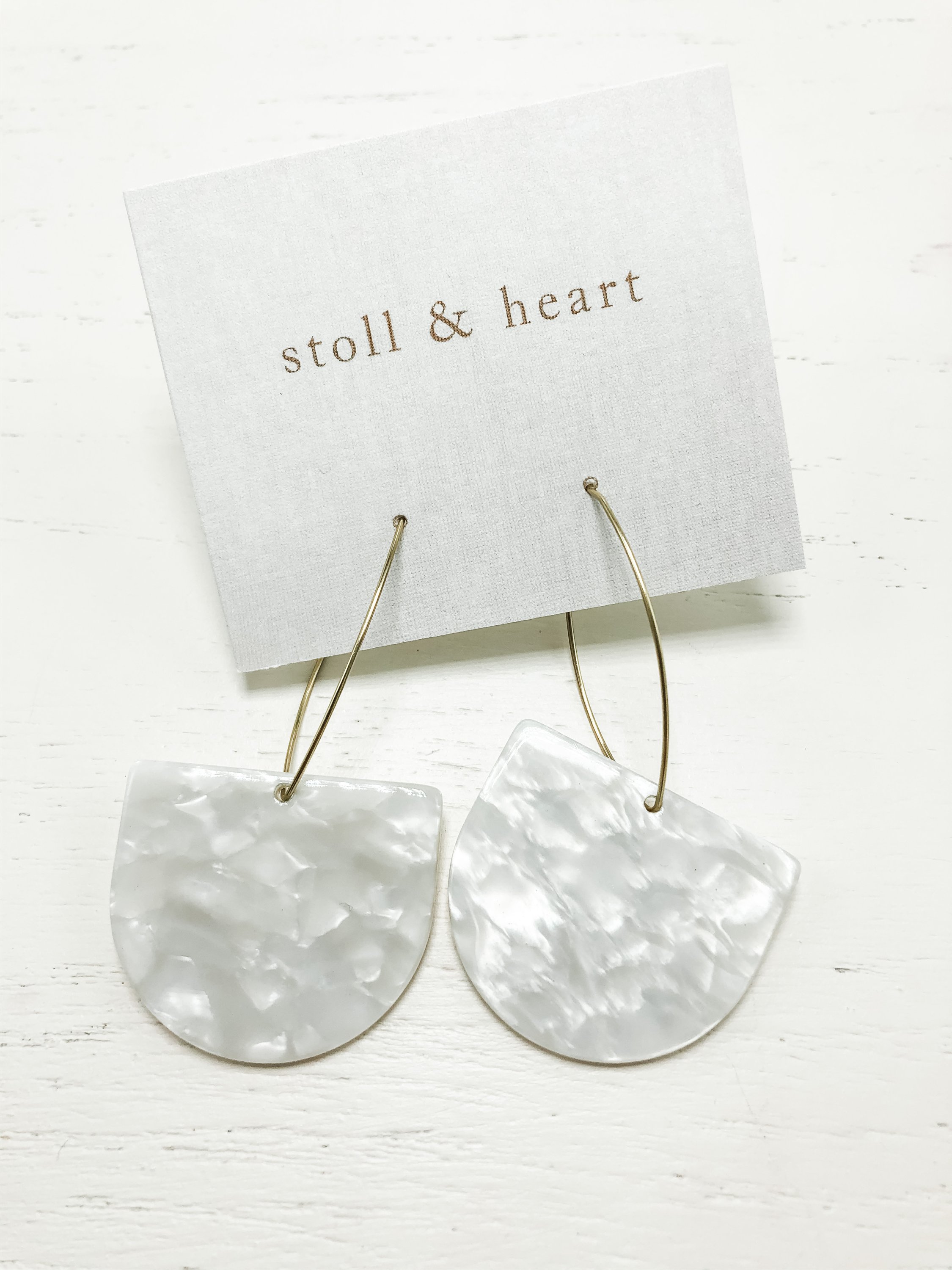 A pair of elegant earrings featuring brass hoops and white tortoise shell resin, measuring approximately 2-7/8 inches in length.