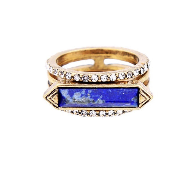 A beautiful 3-piece ring set featuring a Lapis Lazuli center stone with an antique gold finish, elegantly displayed.