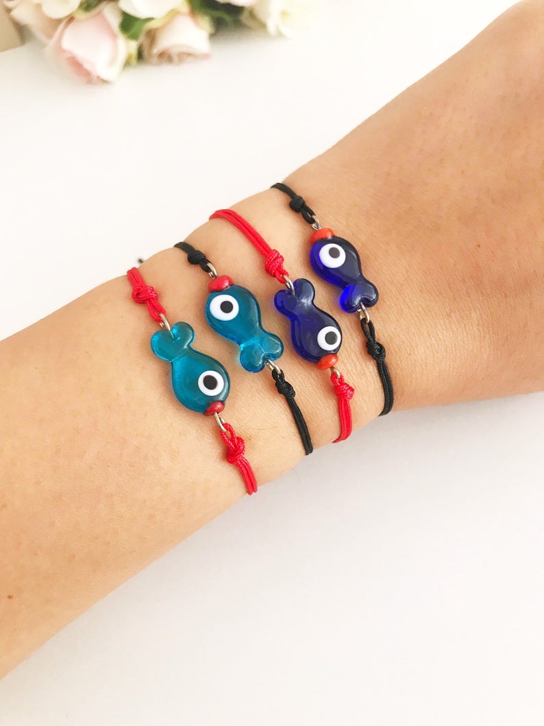 Handmade Thread Evil Eye Bracelet featuring Murano glass fish charm in turquoise and blue colors, adjustable thread design.