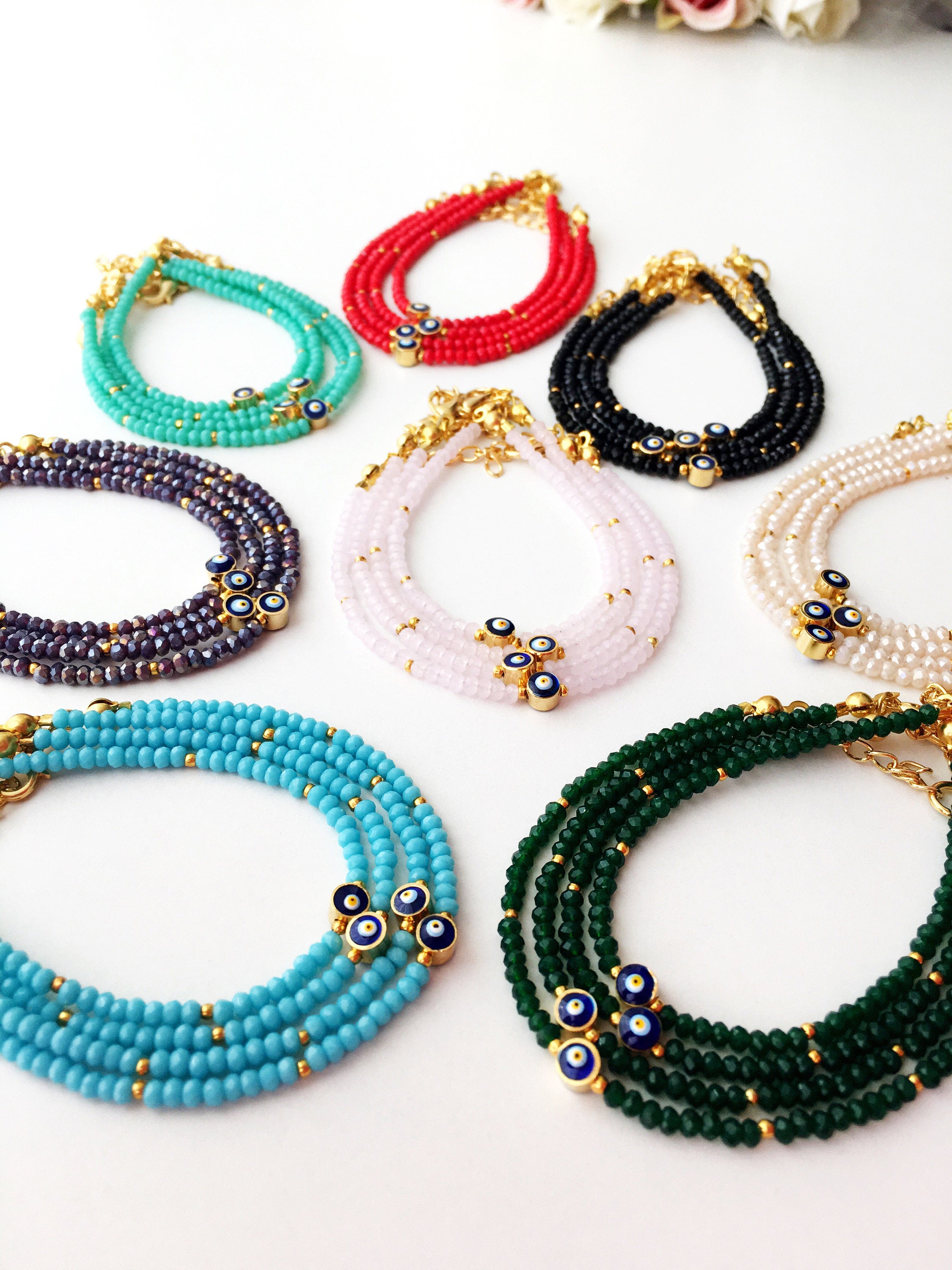 A colorful Tiny Evil Eye Bracelet made with Miyuki seed beads featuring a protective evil eye charm, showcasing vibrant colors.