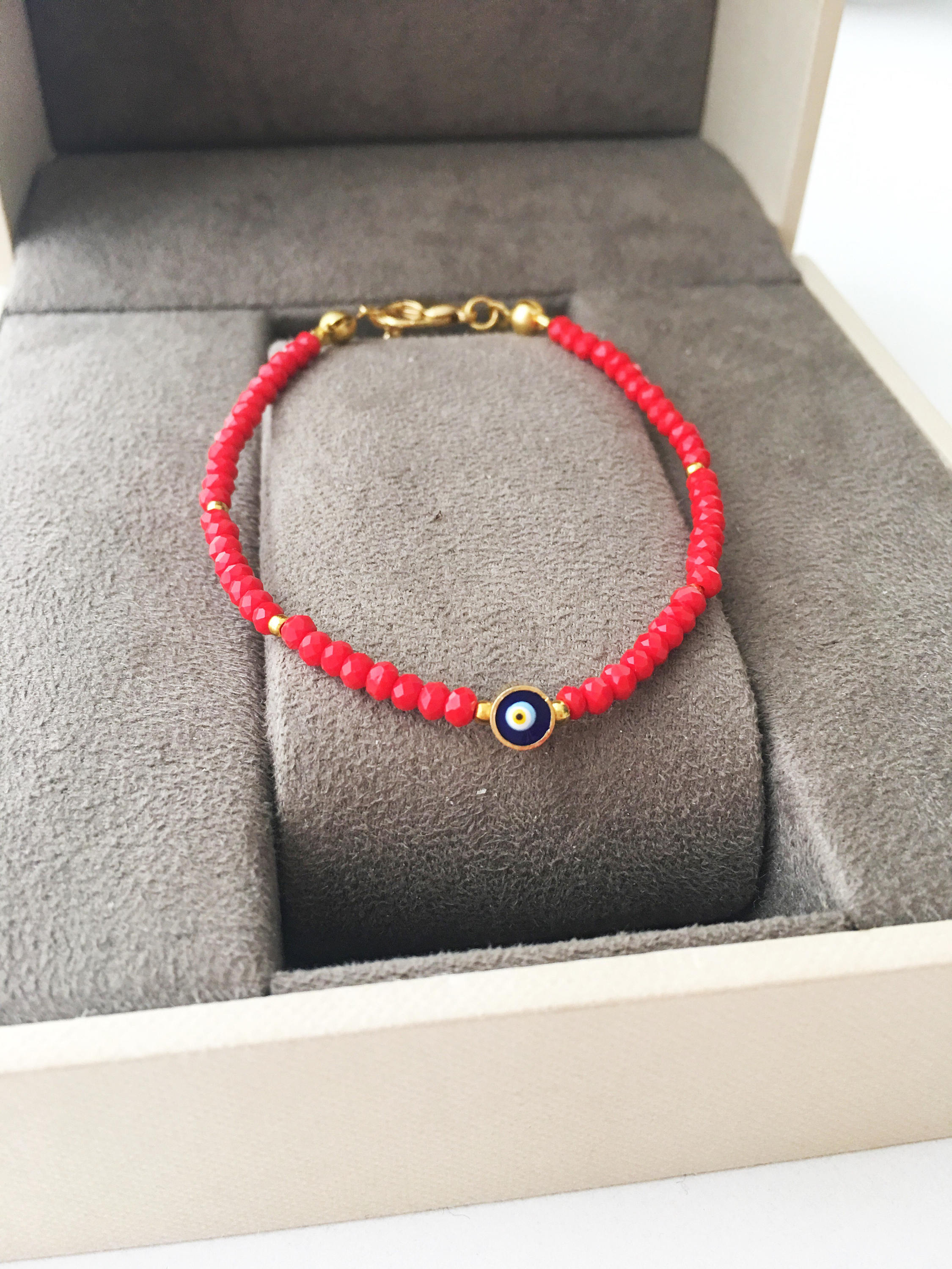 A colorful Tiny Evil Eye Bracelet made with Miyuki seed beads featuring a protective evil eye charm, showcasing vibrant colors.