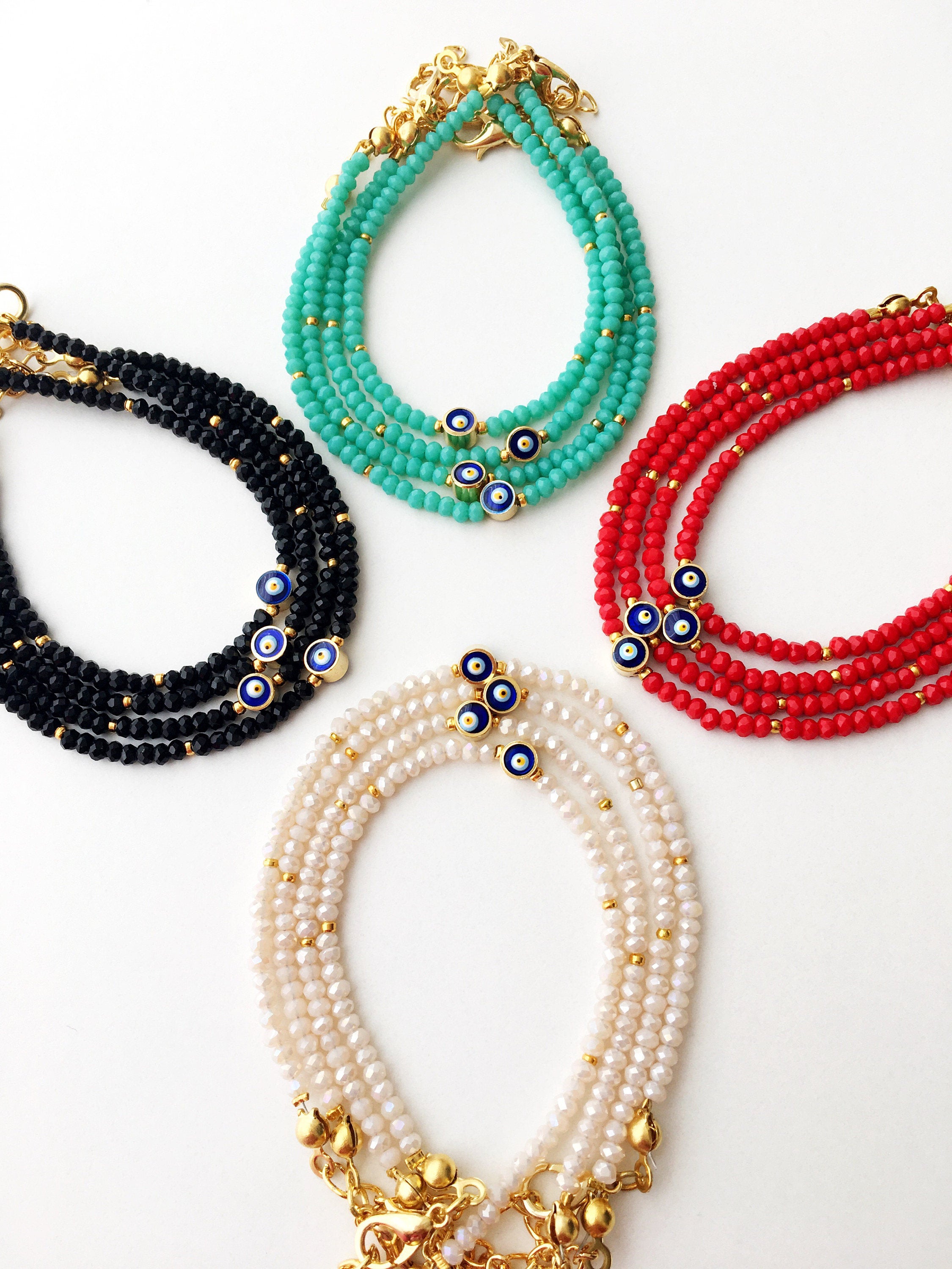 A colorful Tiny Evil Eye Bracelet made with Miyuki seed beads featuring a protective evil eye charm, showcasing vibrant colors.