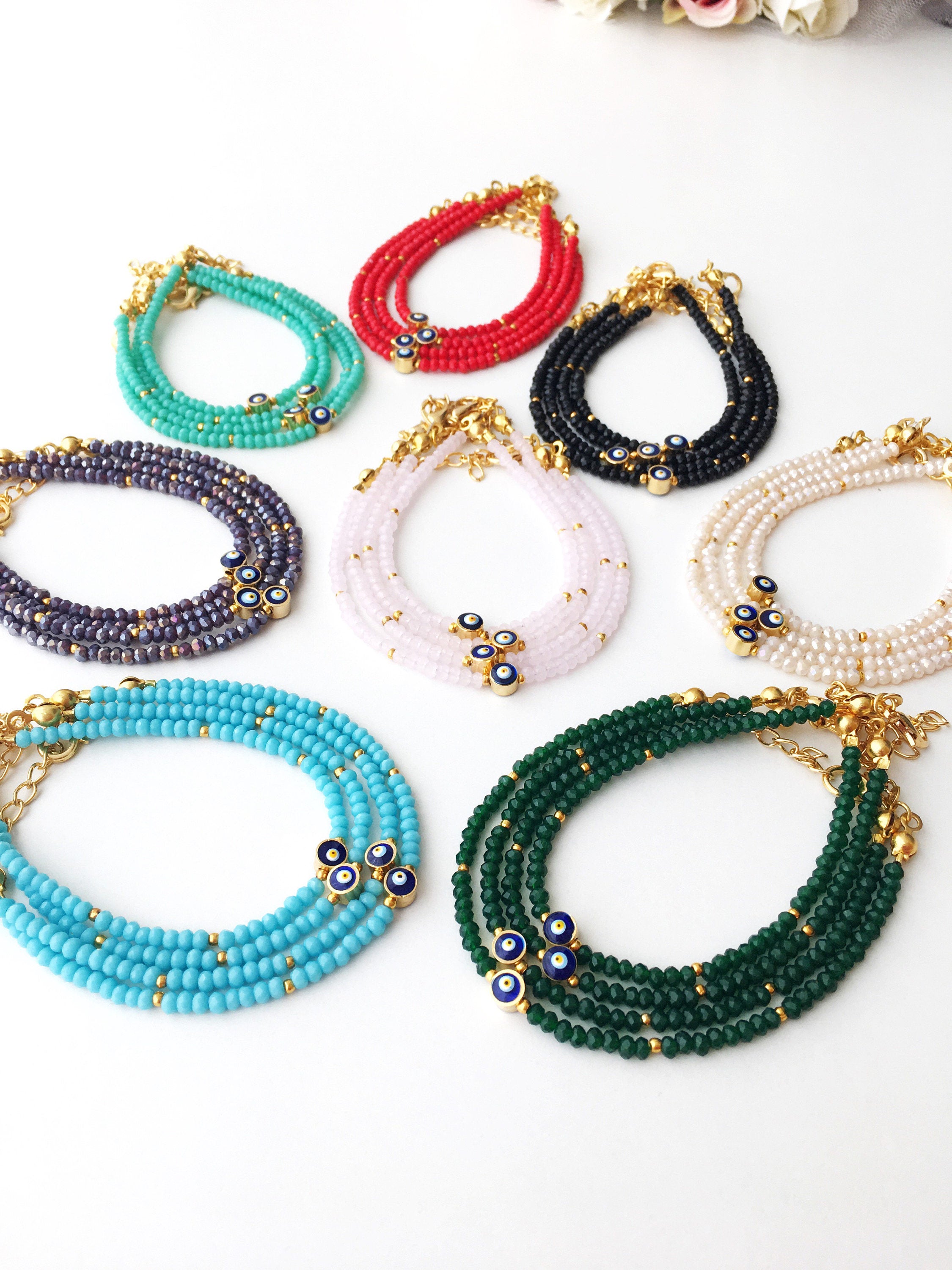 A colorful Tiny Evil Eye Bracelet made with Miyuki seed beads featuring a protective evil eye charm, showcasing vibrant colors.