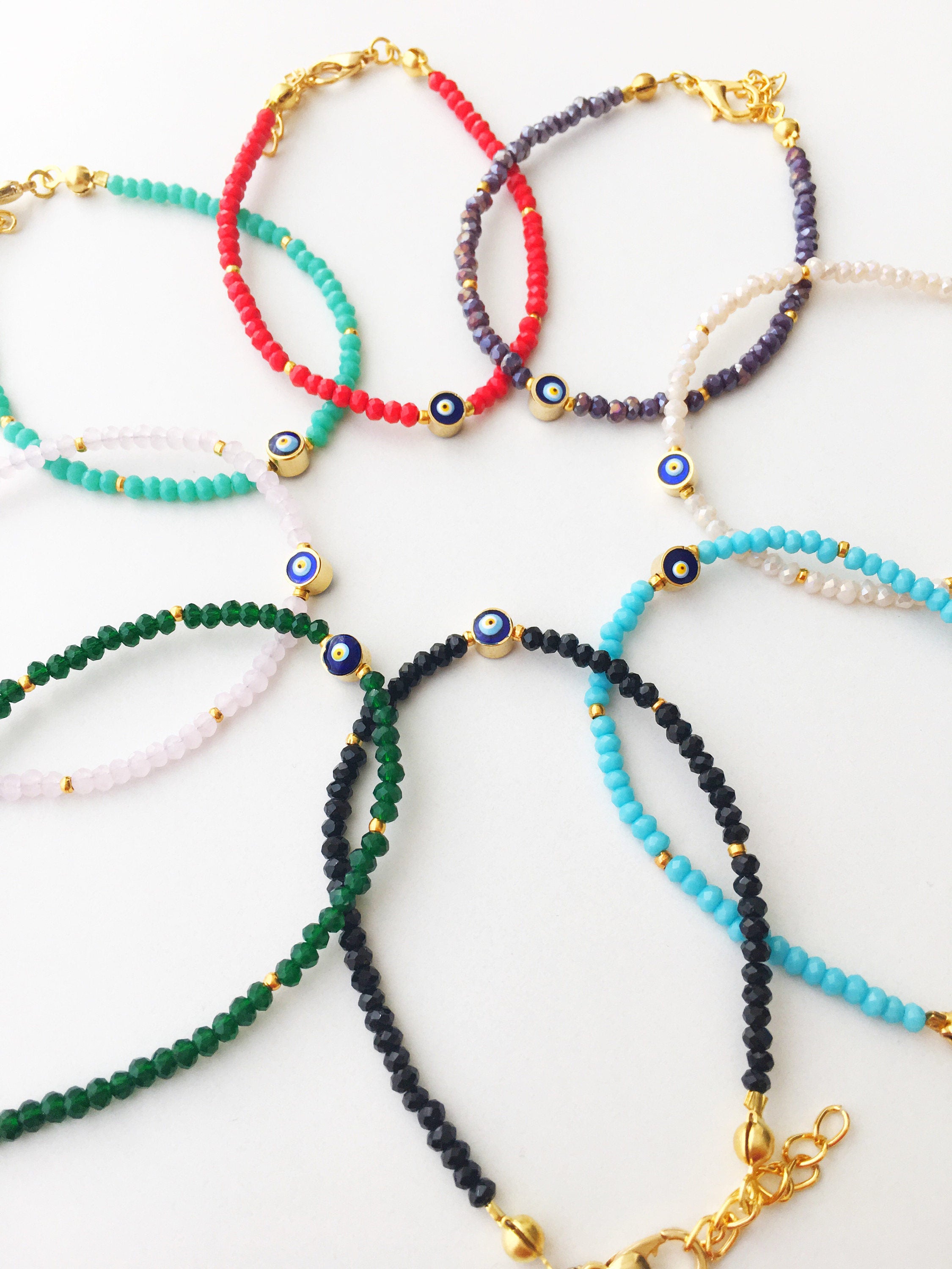 A colorful Tiny Evil Eye Bracelet made with Miyuki seed beads featuring a protective evil eye charm, showcasing vibrant colors.