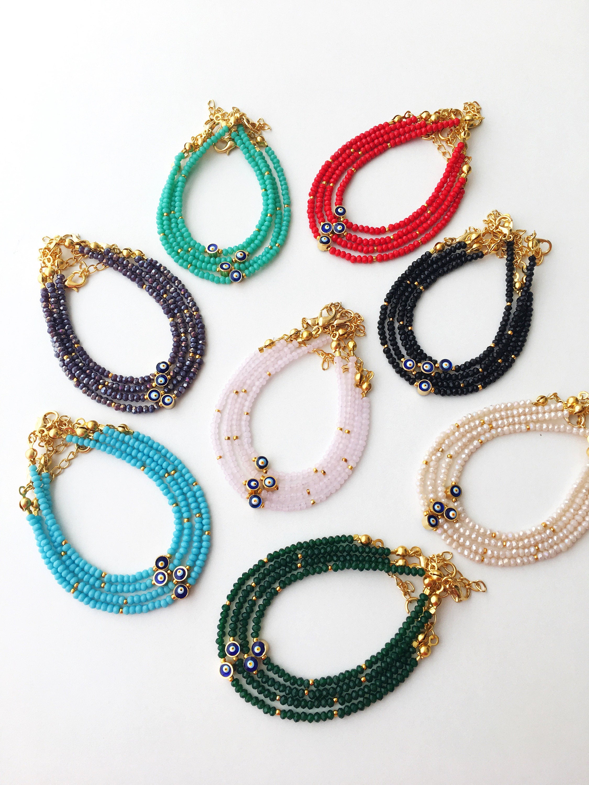 A colorful Tiny Evil Eye Bracelet made with Miyuki seed beads featuring a protective evil eye charm, showcasing vibrant colors.