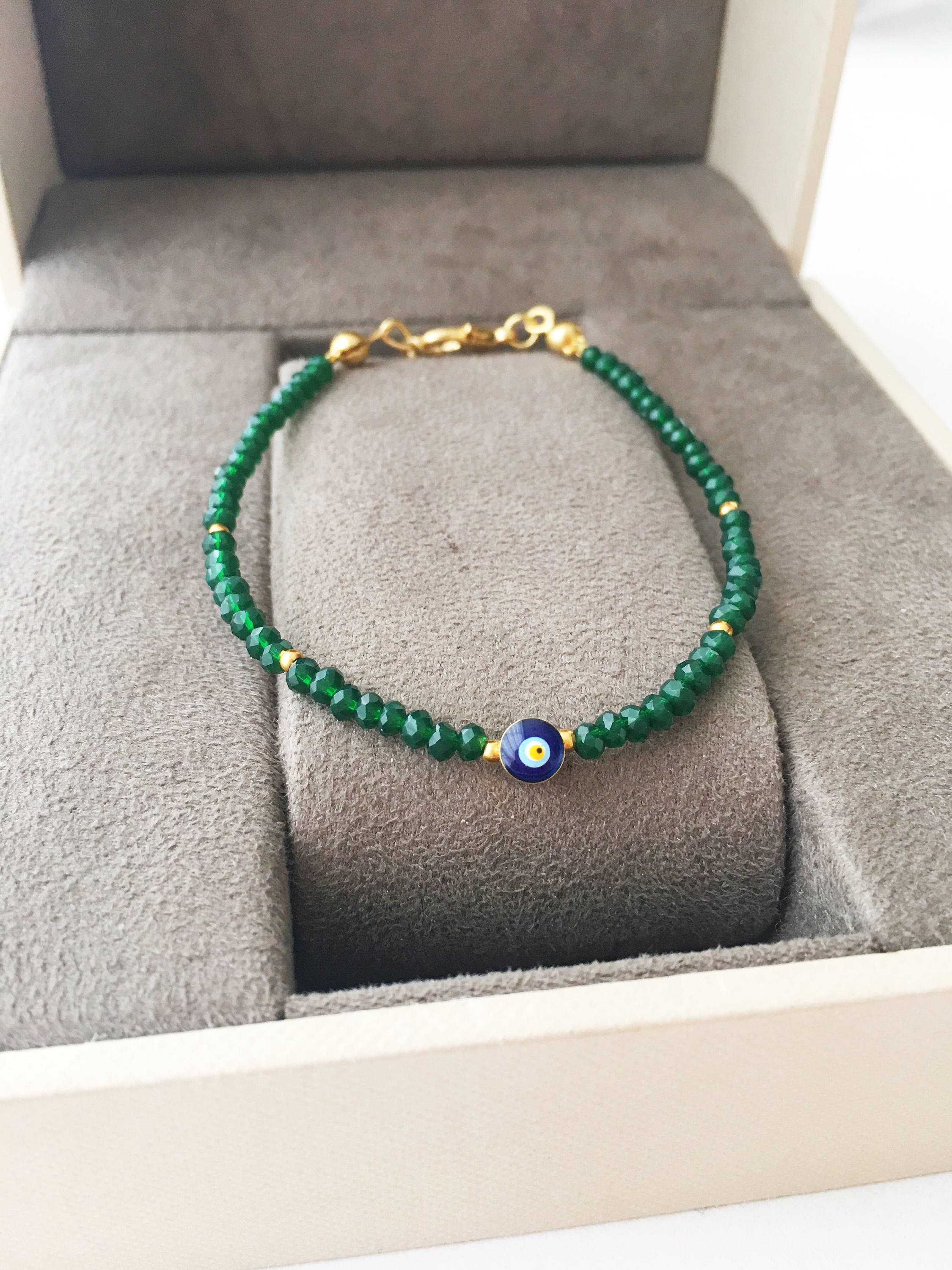 A colorful Tiny Evil Eye Bracelet made with Miyuki seed beads featuring a protective evil eye charm, showcasing vibrant colors.