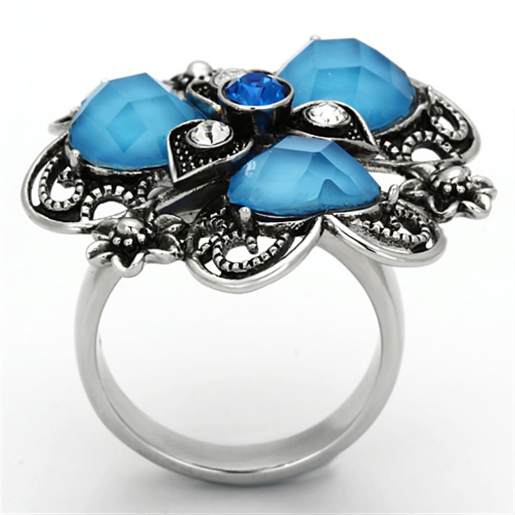 High polished stainless steel ring featuring a sea blue synthetic stone, showcasing a sleek and elegant design.