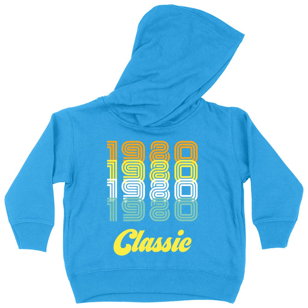 Toddler wearing a colorful 1980 Classic Hoodie, showcasing its soft fabric and stylish design.