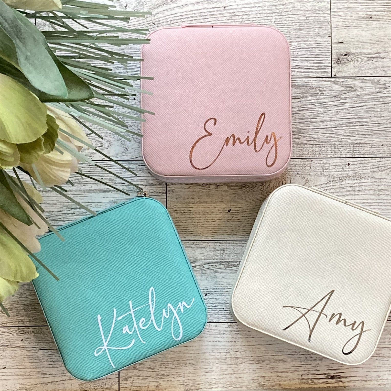 Personalized travel jewelry box in cream, light pink, and mint colors with customizable name options.