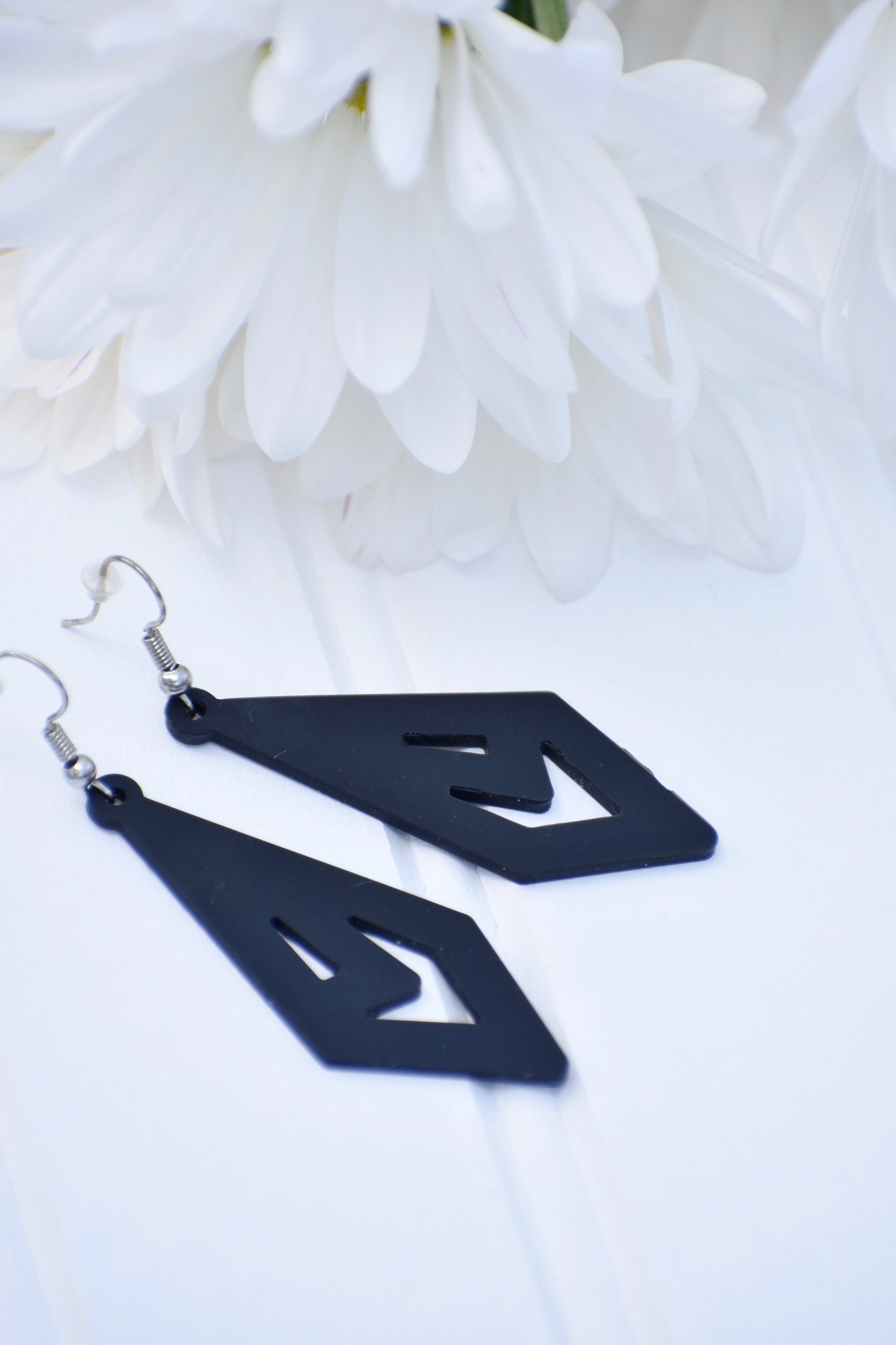 A pair of trendy earrings displayed elegantly, showcasing their unique design and lightweight features.