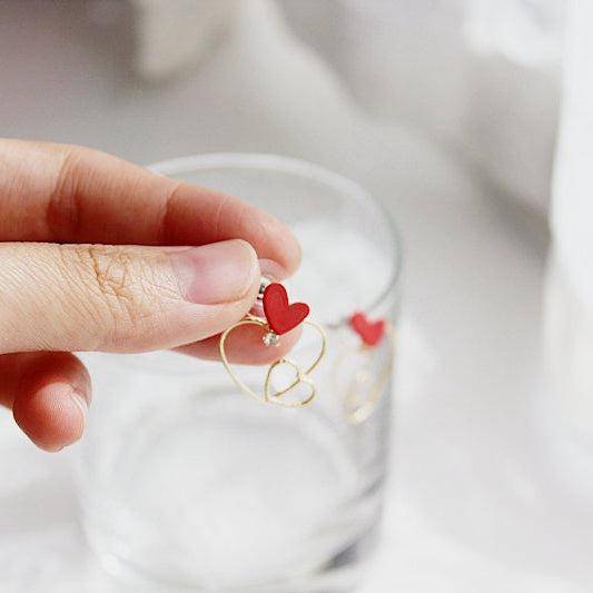 Triple Hearts Earrings featuring red and gold heart studs, symbolizing love and affection, elegantly designed for gifting or personal wear.