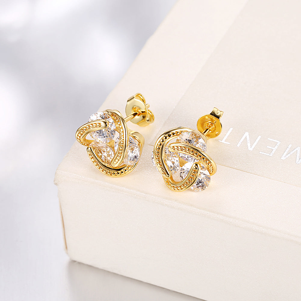 Triple Stone Knot Stud Earrings in 18K gold plating with sparkling crystals, elegantly displayed in a white gift box.