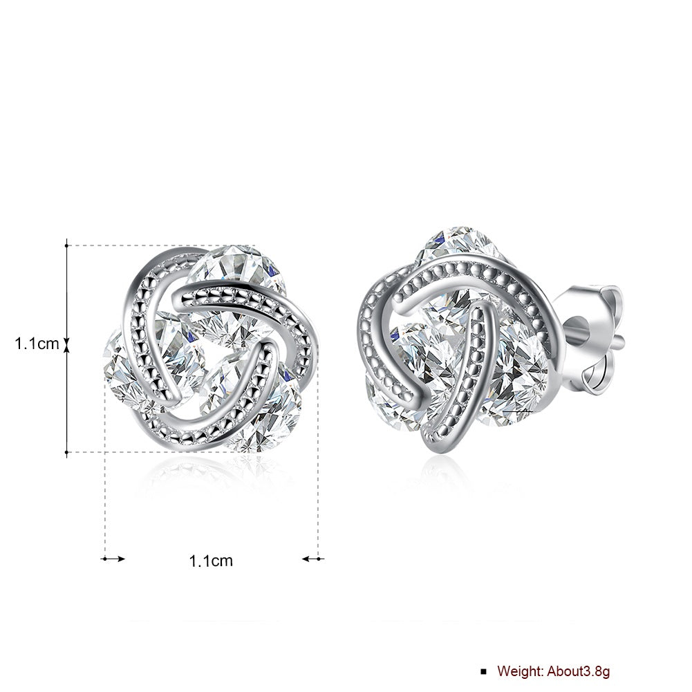 Triple Stone Knot Stud Earrings in 18K White Gold Plated with Crystals, featuring a unique design and sparkling stones.
