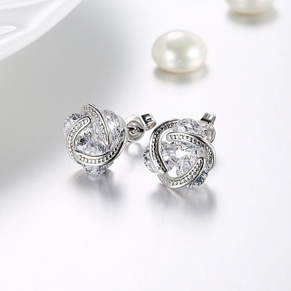 Triple Stone Knot Stud Earrings in 18K White Gold Plated with Crystals, featuring a unique design and sparkling stones.