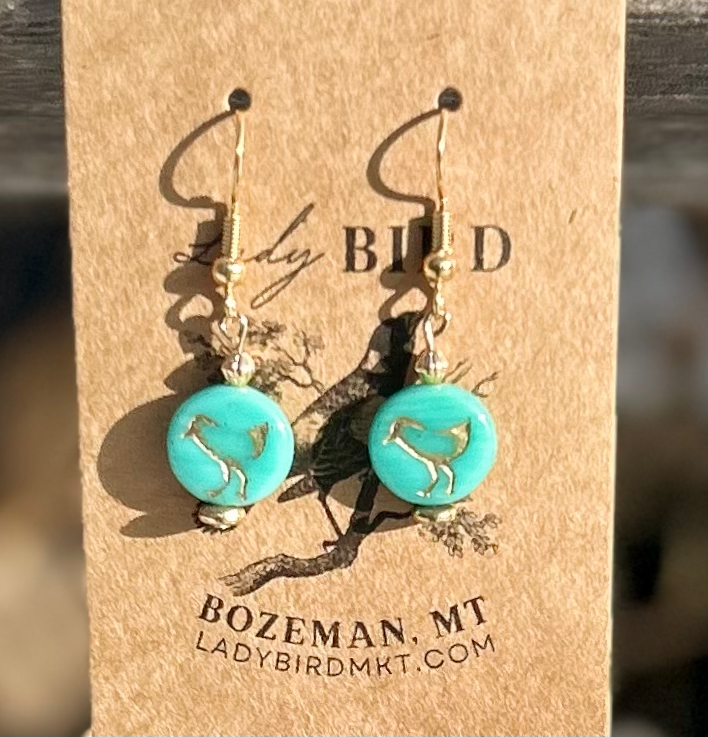 Turquoise blue and gold etched glass earrings featuring a bird motif, showcasing Czech glass coin beads.