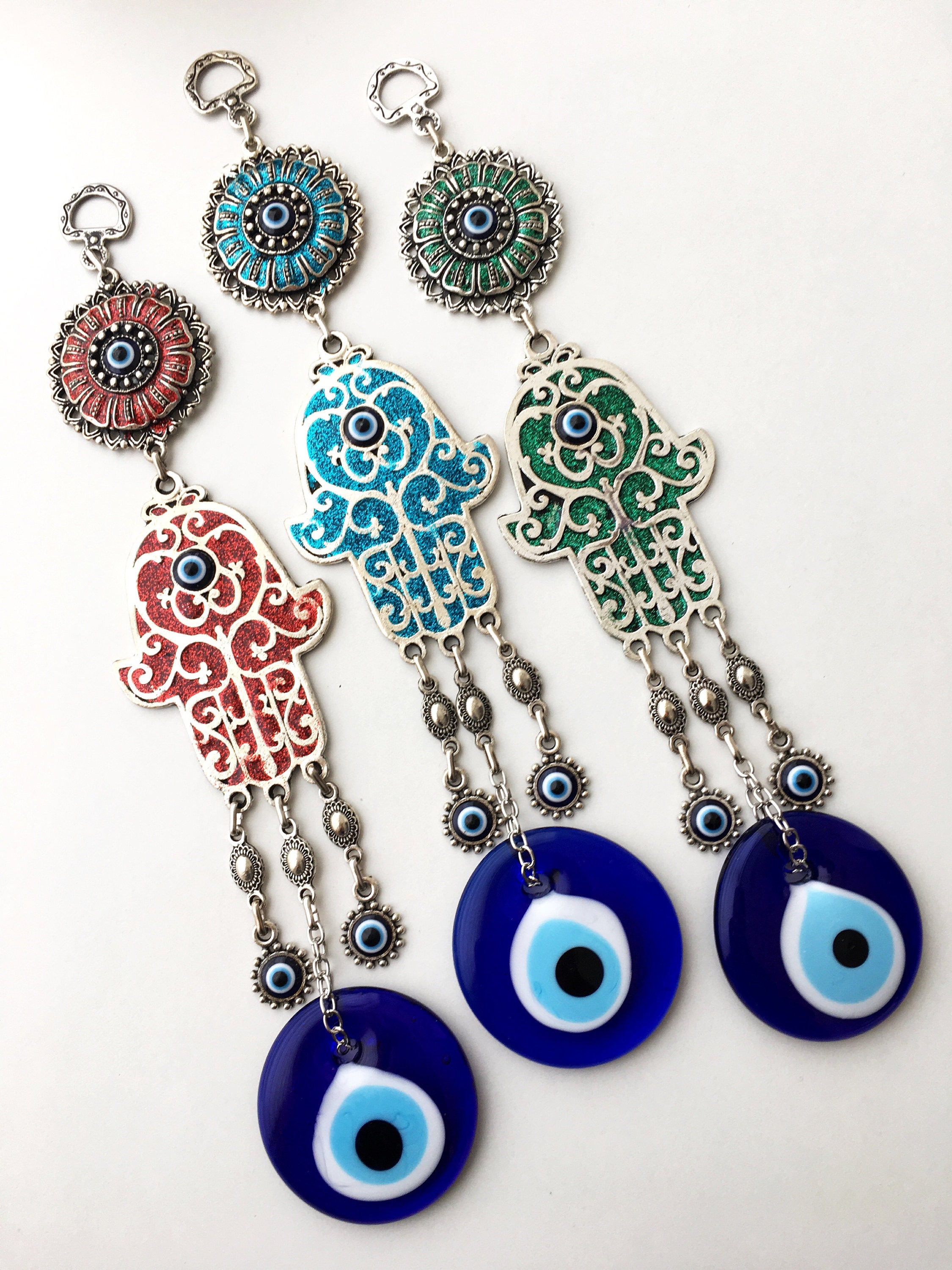 Turquoise Hamsa Evil Eye Wall Hanging featuring a mosaic metal hamsa hand and a large glass evil eye bead, symbolizing protection and good luck.