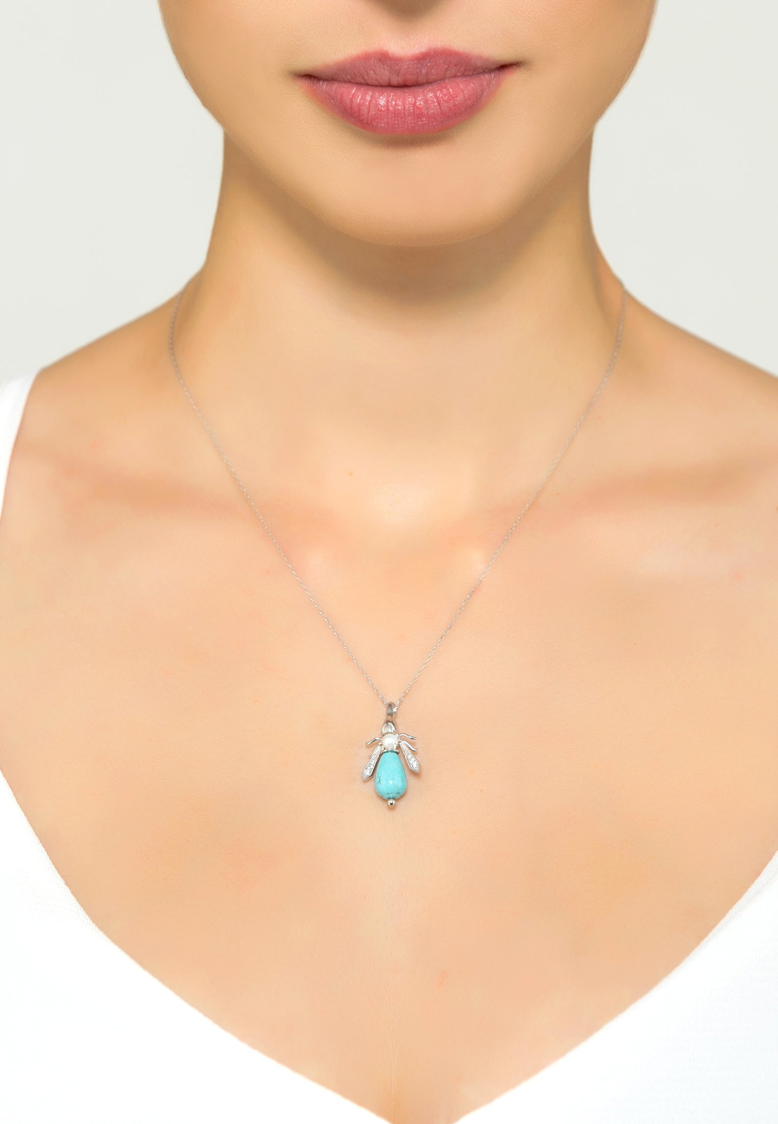Turquoise and pearl honey bee necklace in sterling silver, featuring a turquoise body and pearl head, elegantly designed for everyday wear.